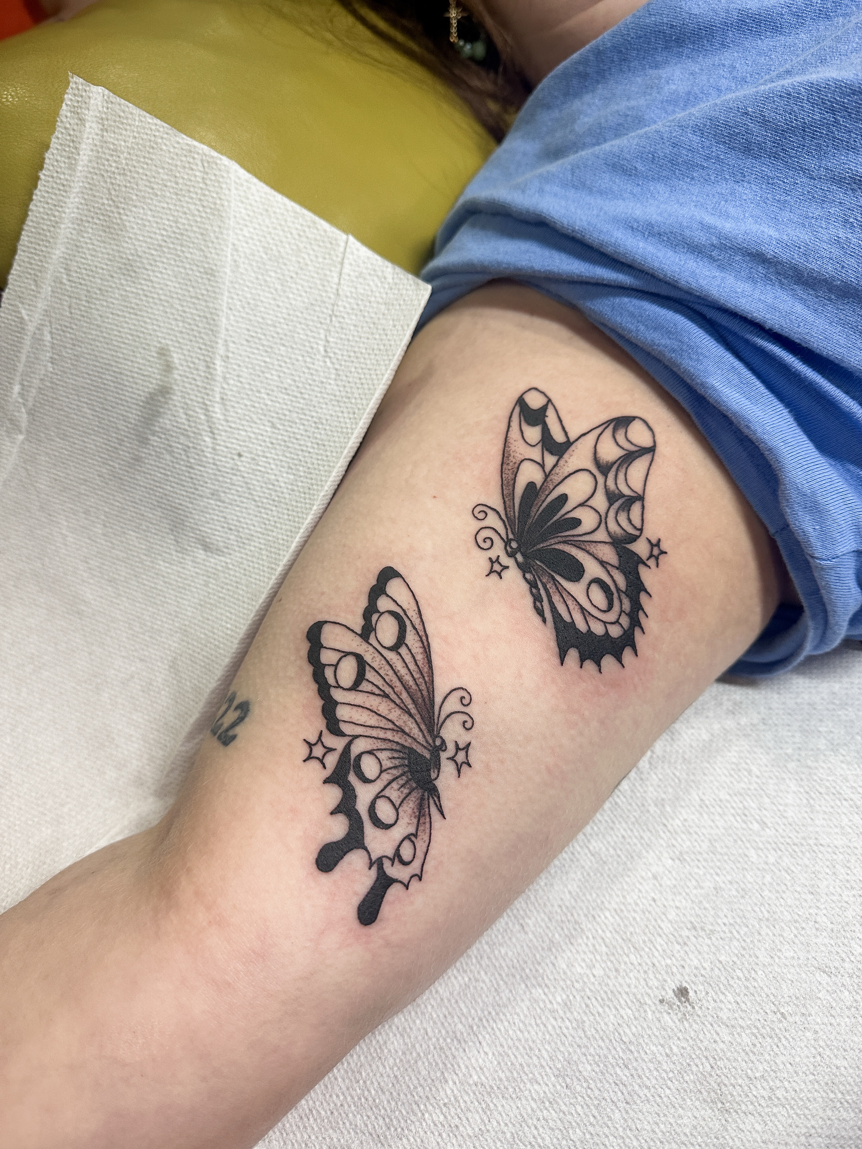 Butterflies black and grey tattoo on the forearm by Hannah Eddy