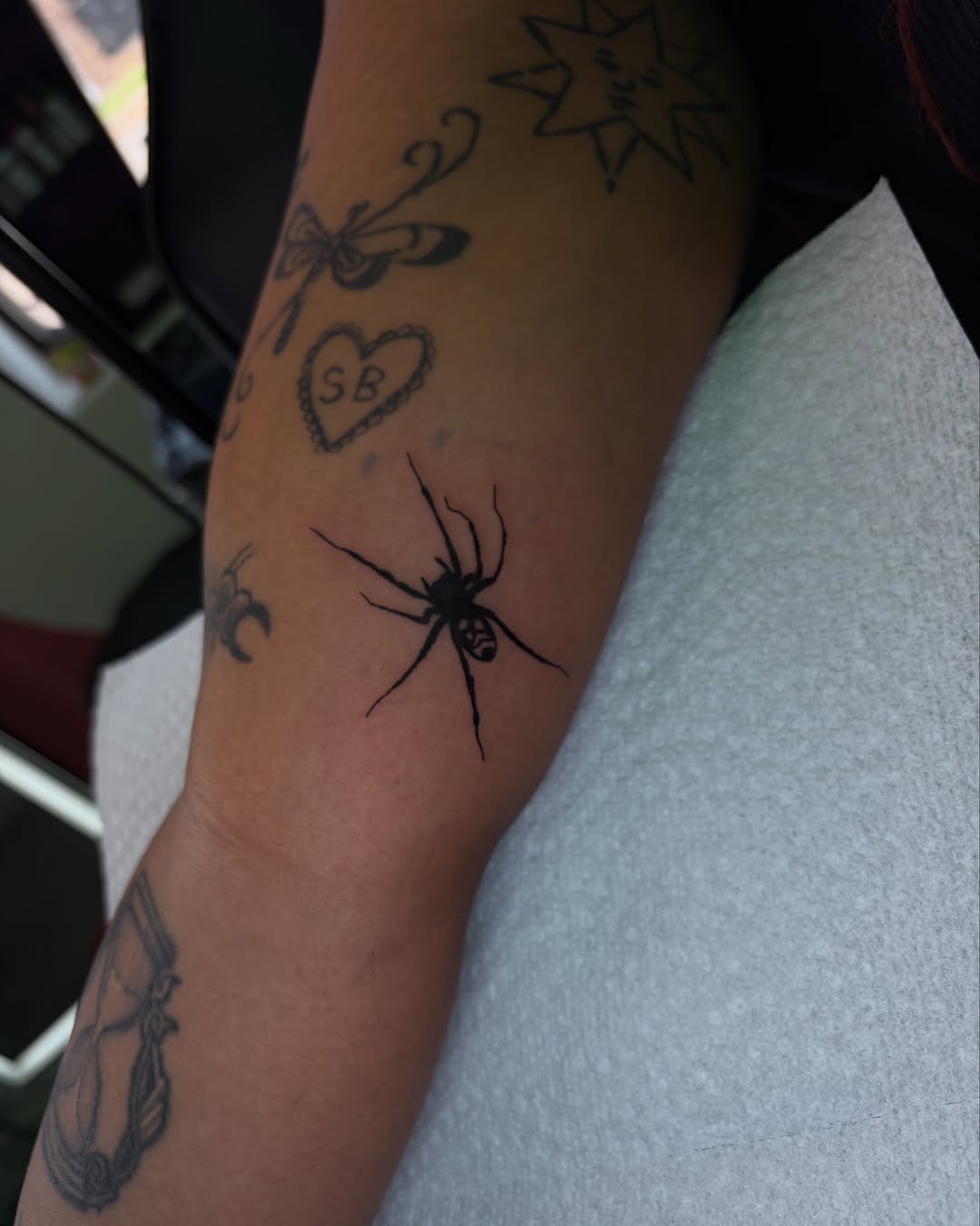 Spider black and grey tattoo on the forearm by Daniela
