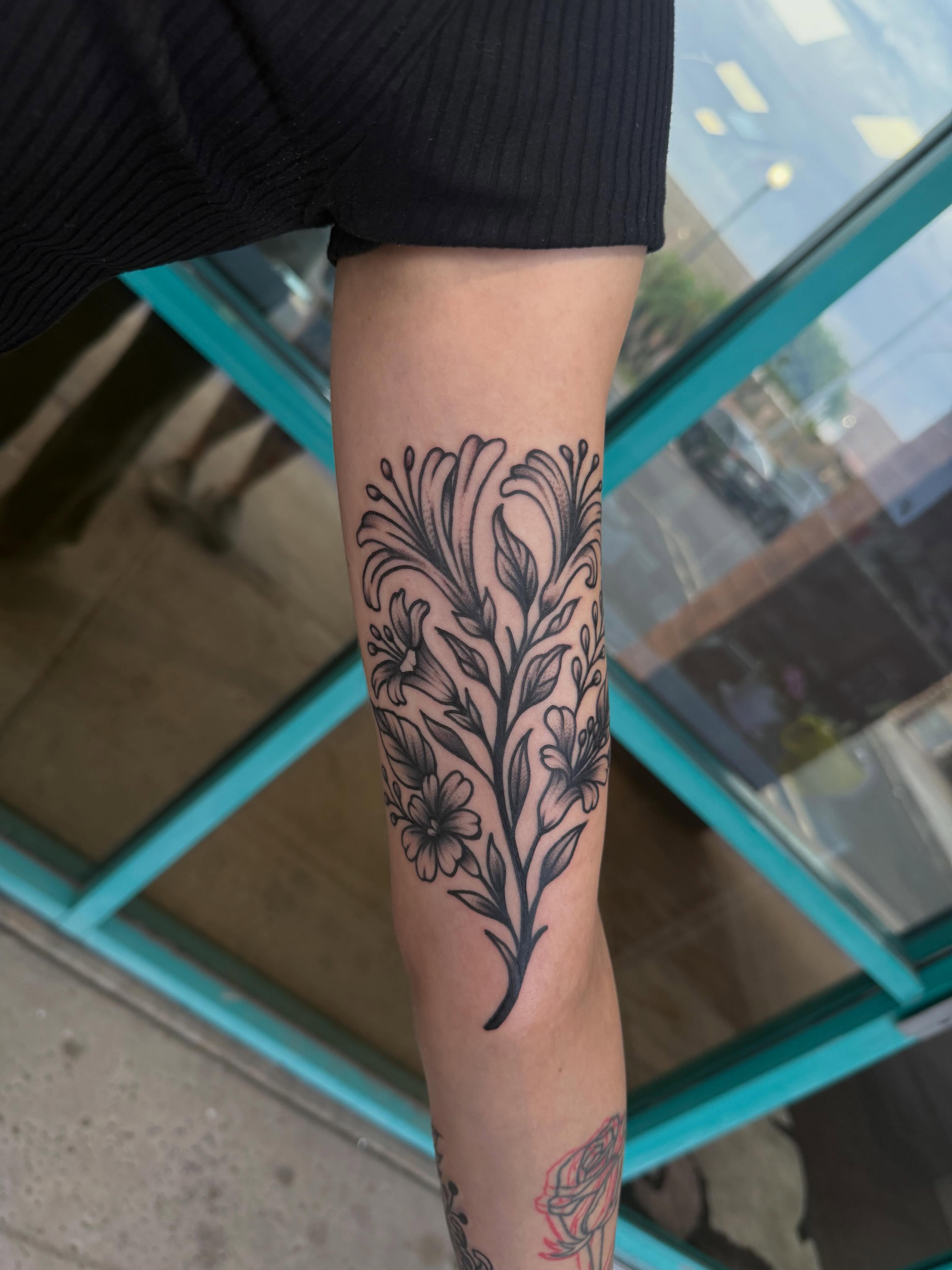 Floral vine black and grey tattoo on the forearm by McKenna Hughes