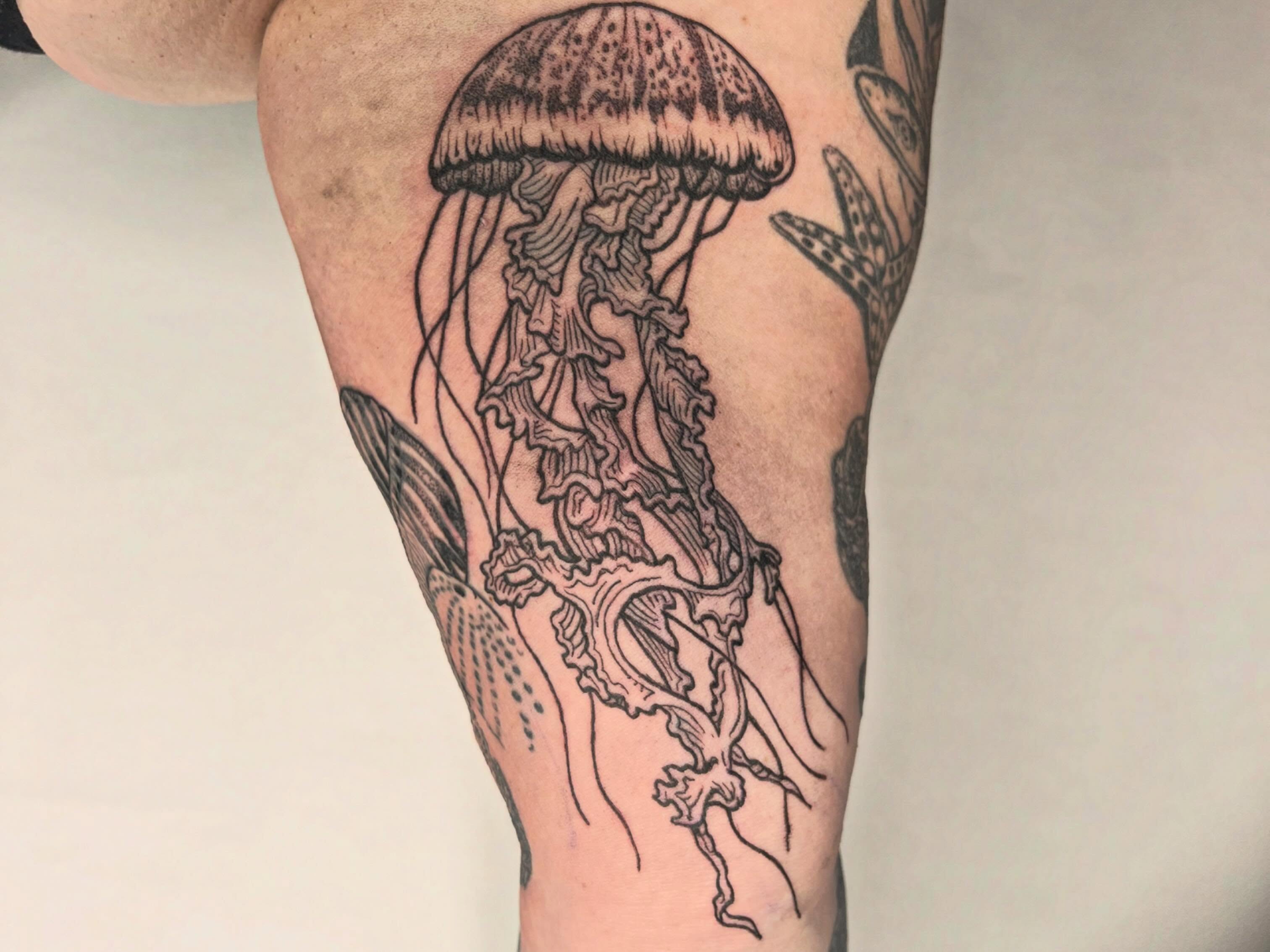 Jellyfish black and grey tattoo on the forearm by Jason Middelton