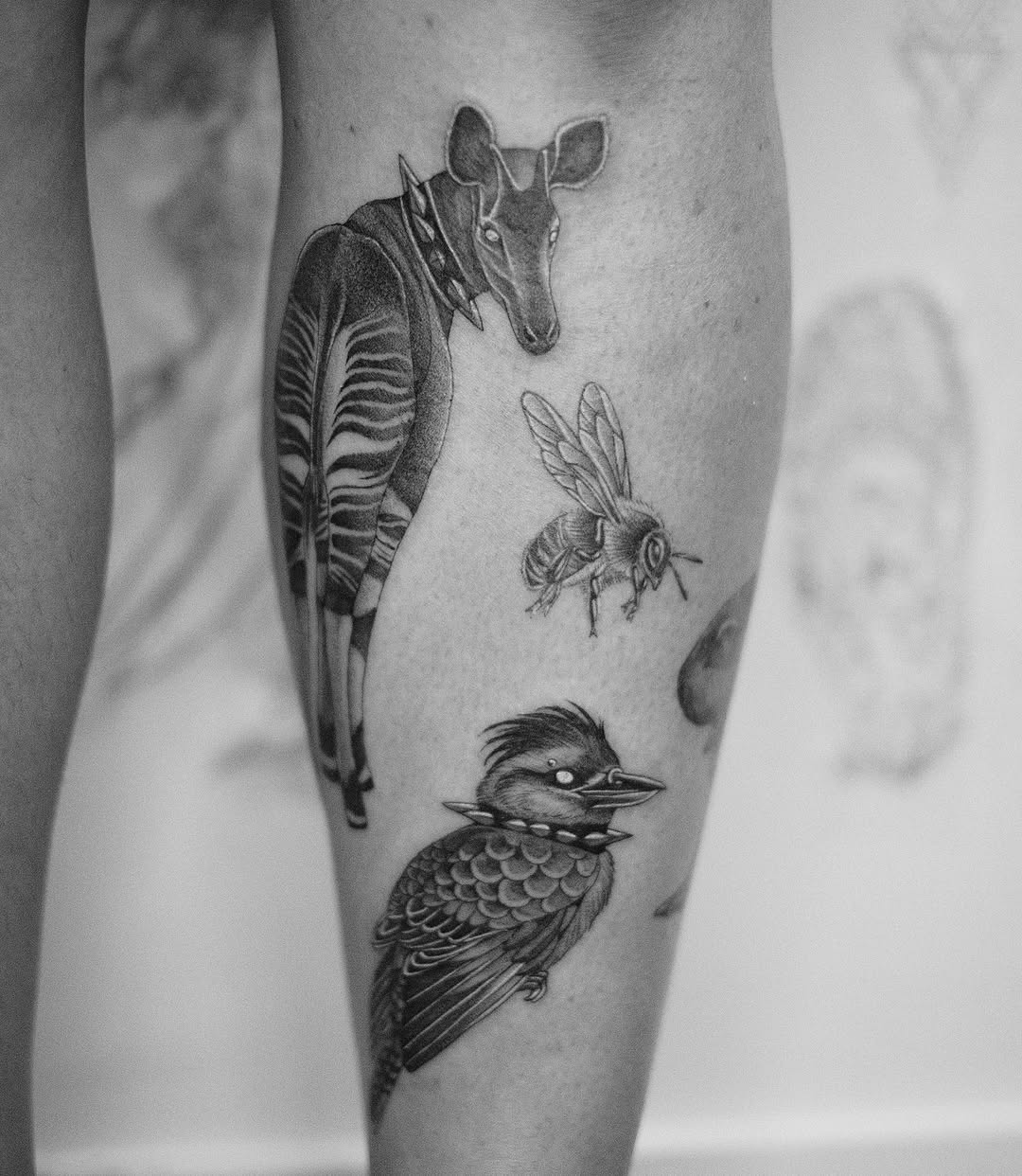 Okapi, bee, bird realism tattoo on the forearm by Isabelle Kellar, San Diego, California