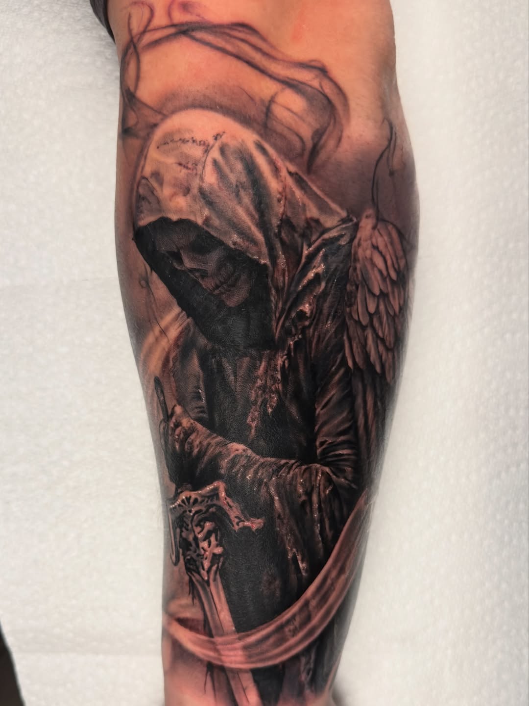 Grim reaper with sword realism tattoo on the forearm by Justin Hay