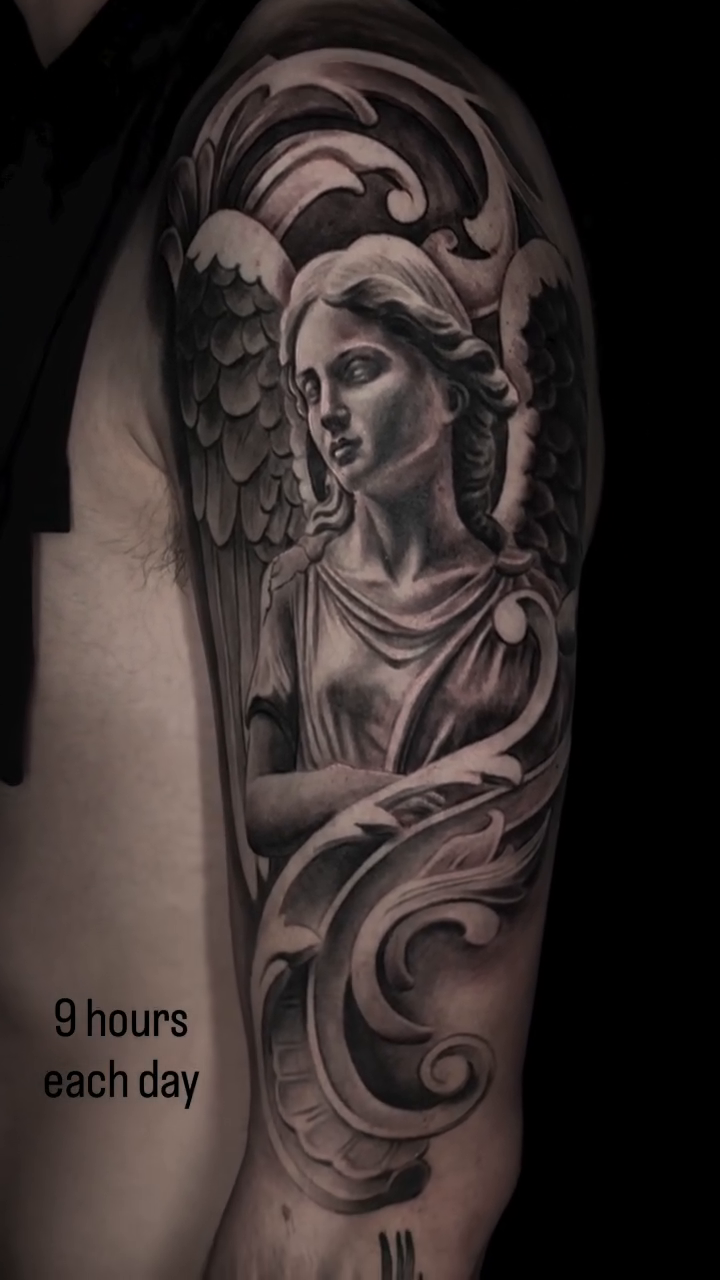 Angel statue tattoo realism tattoo on the upper arm by Jeremiah Warner