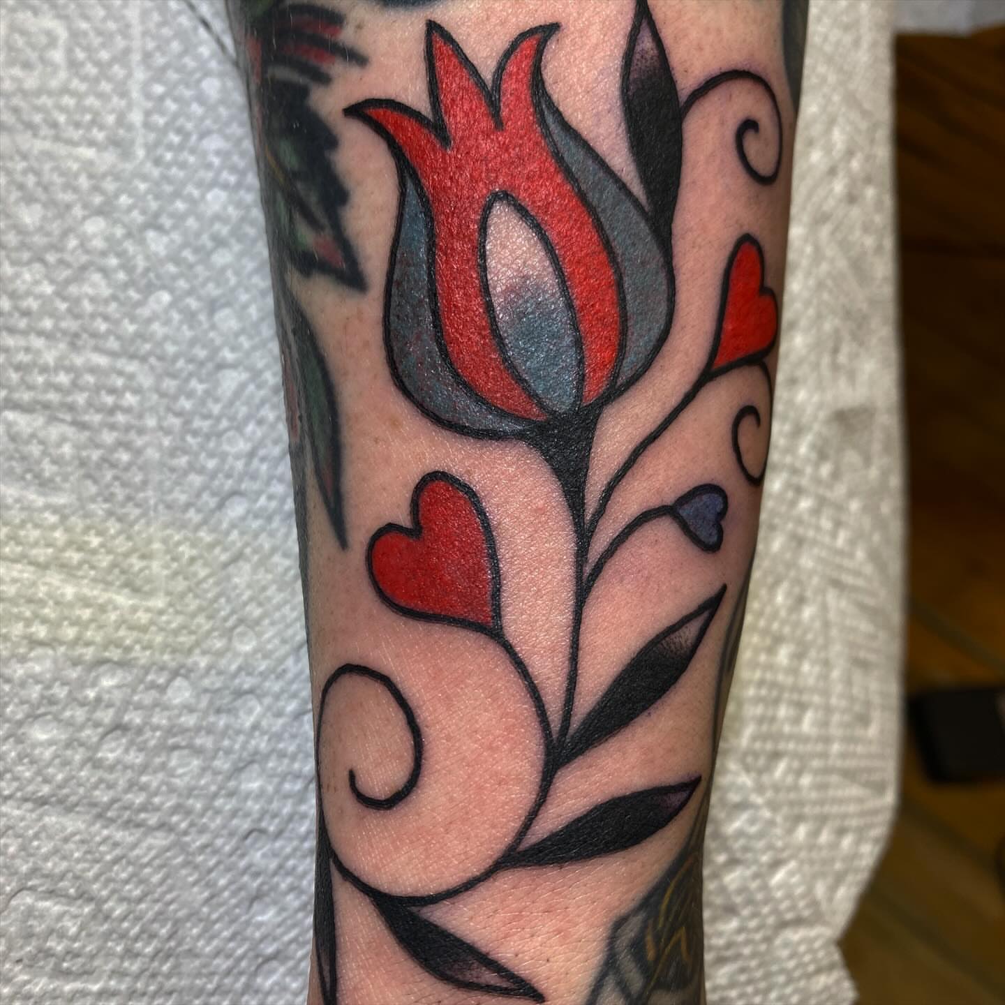 Floral design American traditional tattoo on the forearm by Abby Rose Estes