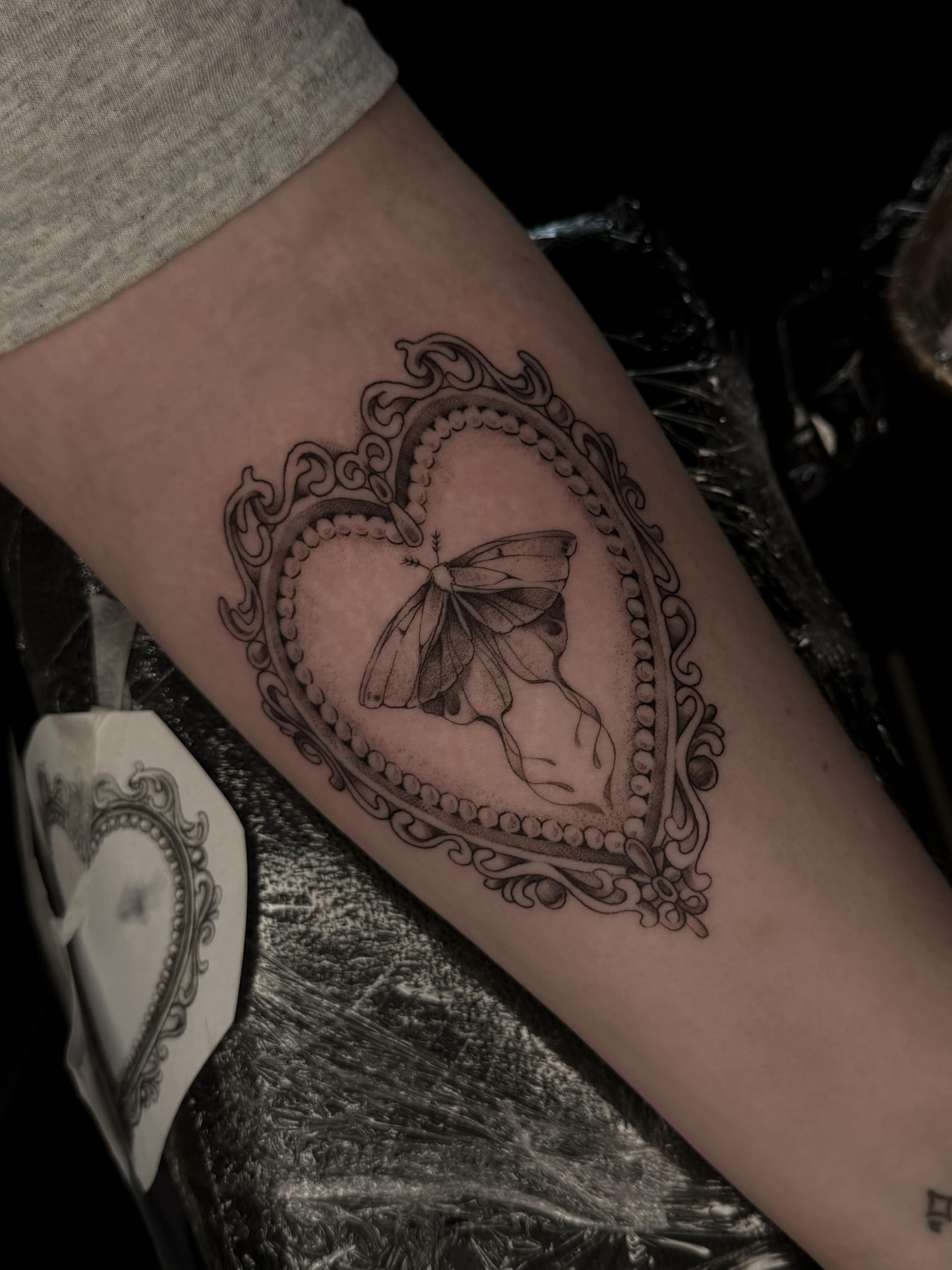 Heart with moth ornamental tattoo on the forearm by Susie Maj