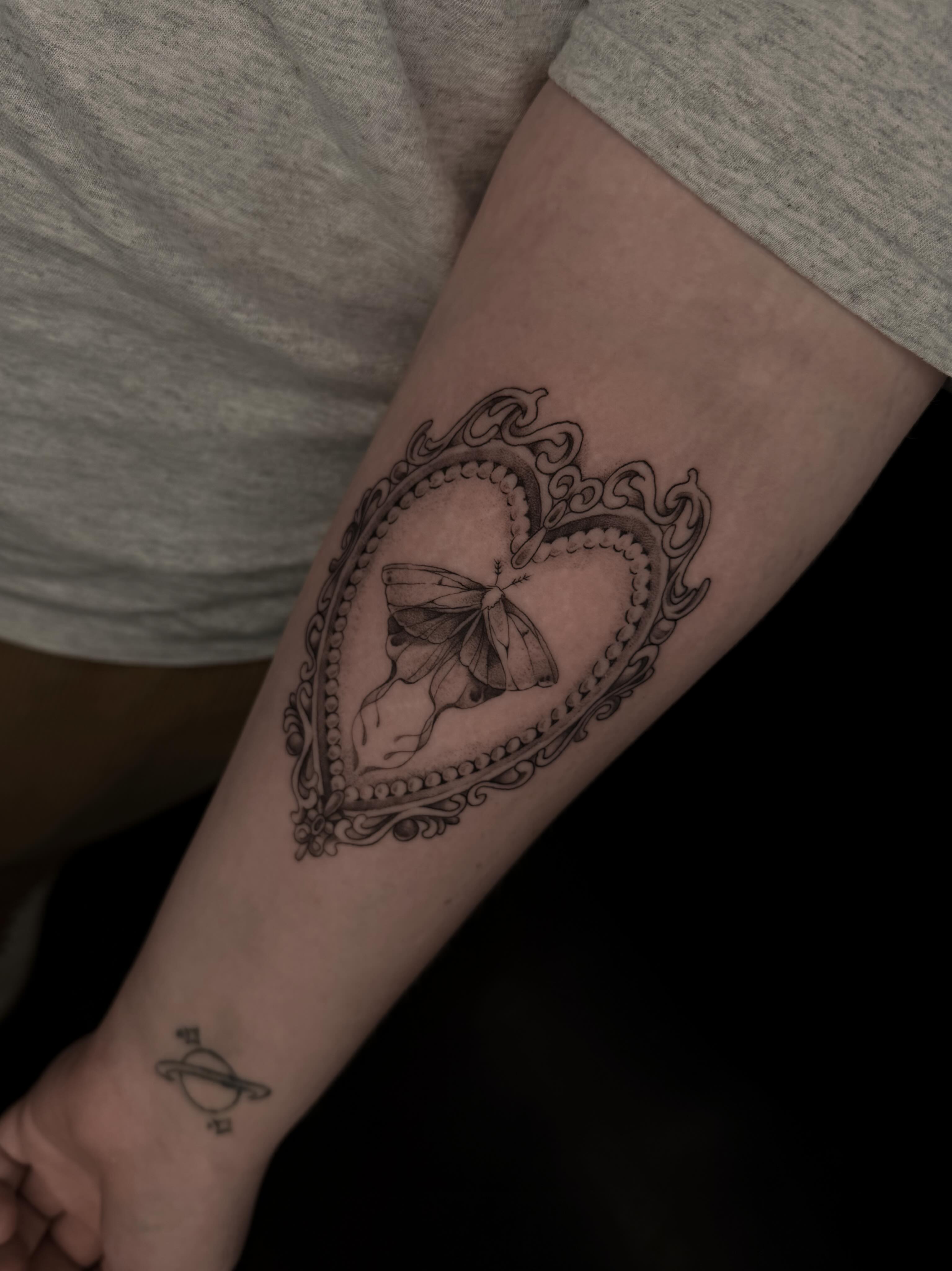Heart with butterfly black and grey tattoo on the forearm by Susie Maj