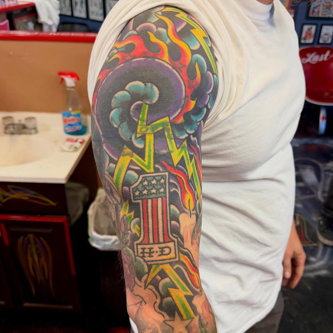 Motorcycle American traditional tattoo on the upper arm by Max mogstad