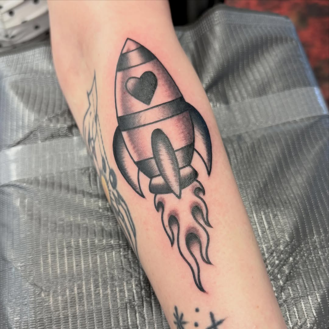 Rocket ship black and grey tattoo on the forearm by Max mogstad