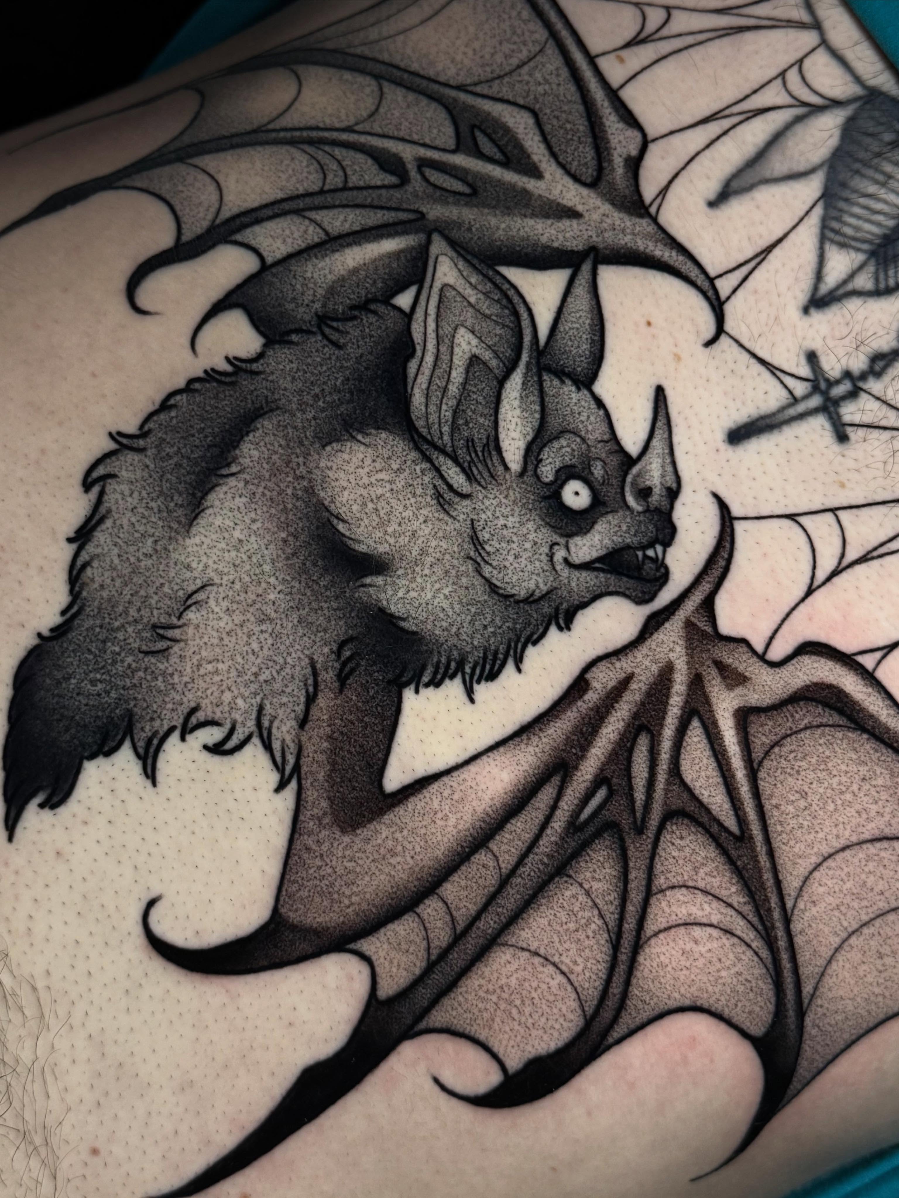 Bat dotwork tattoo on the upper arm by Bell Bolton