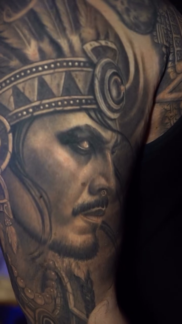 Native American man with headdress realism tattoo by Cristian Rodriguez