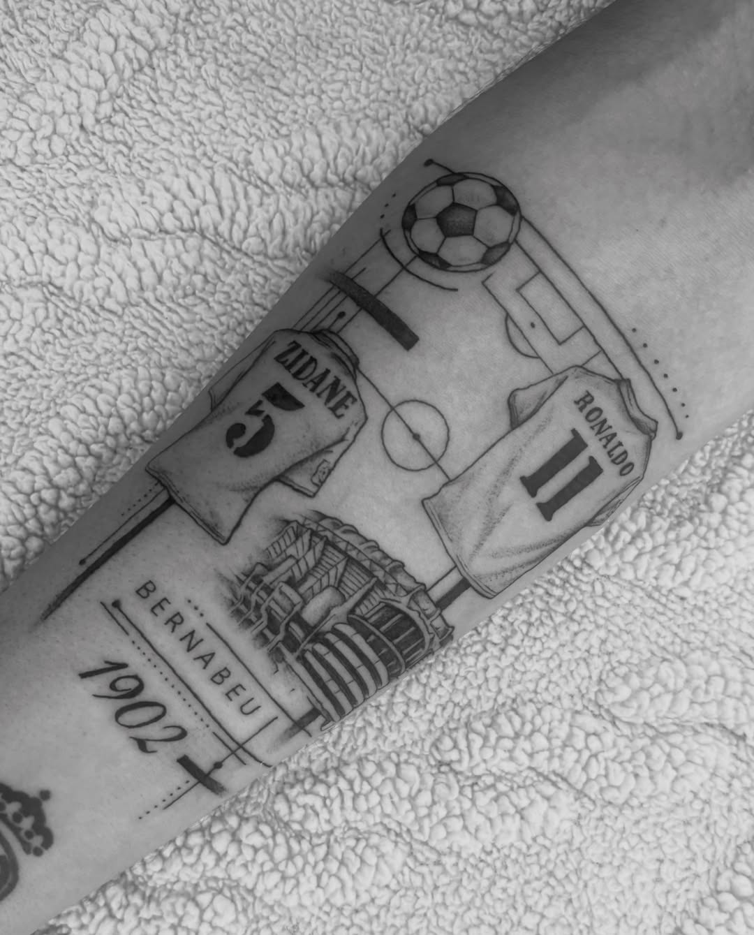 Soccer field black and grey tattoo on the forearm by @secretlinetattoo