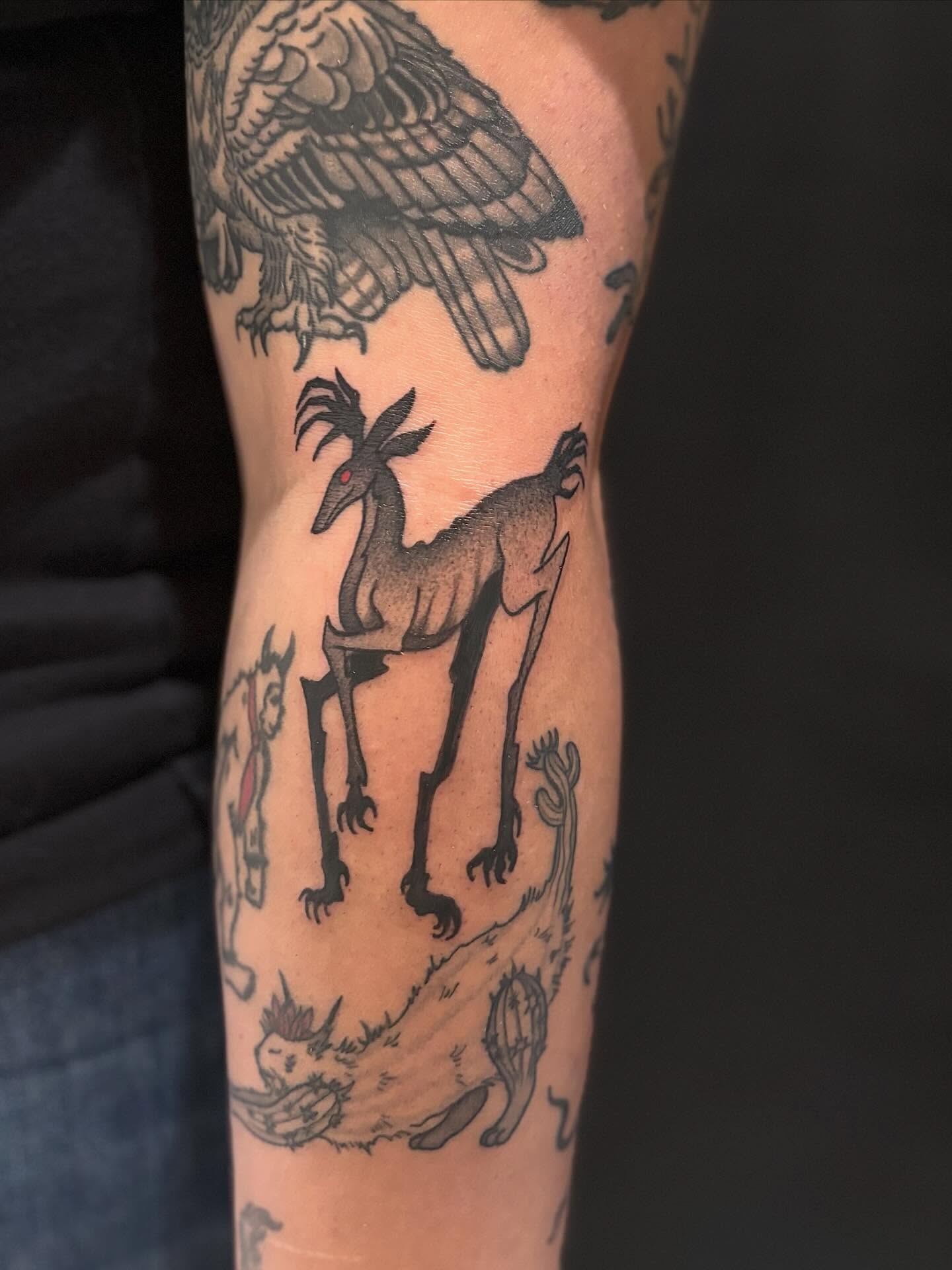 Goat-like creature black and grey tattoo on the forearm by Erica McCullough