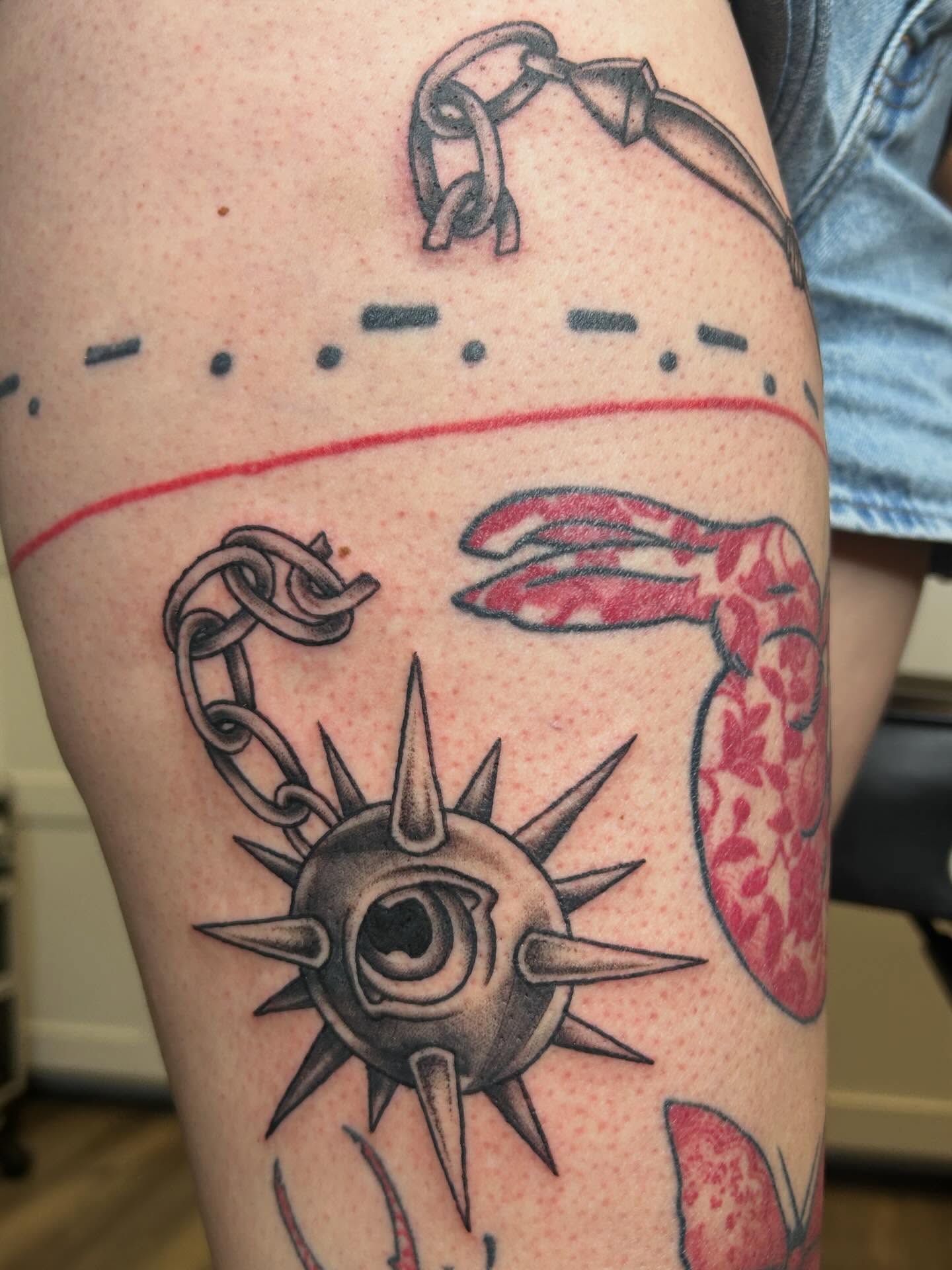 Eye and chain American traditional tattoo on the thigh by Janelle McCarthy