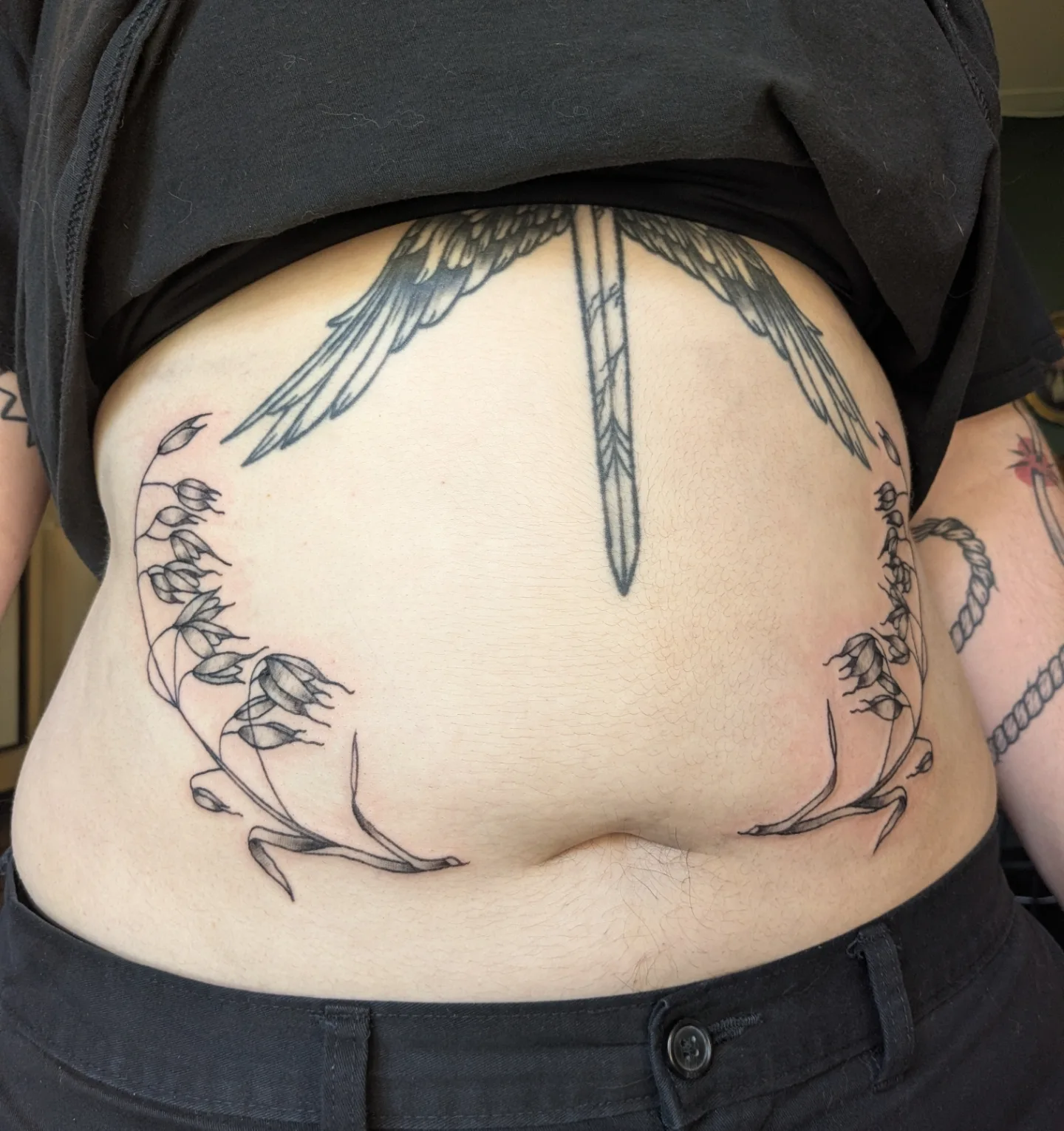 Bird and floral wreath black and grey tattoo on the torso by Madison Cañedo ✺ Portland tattoo