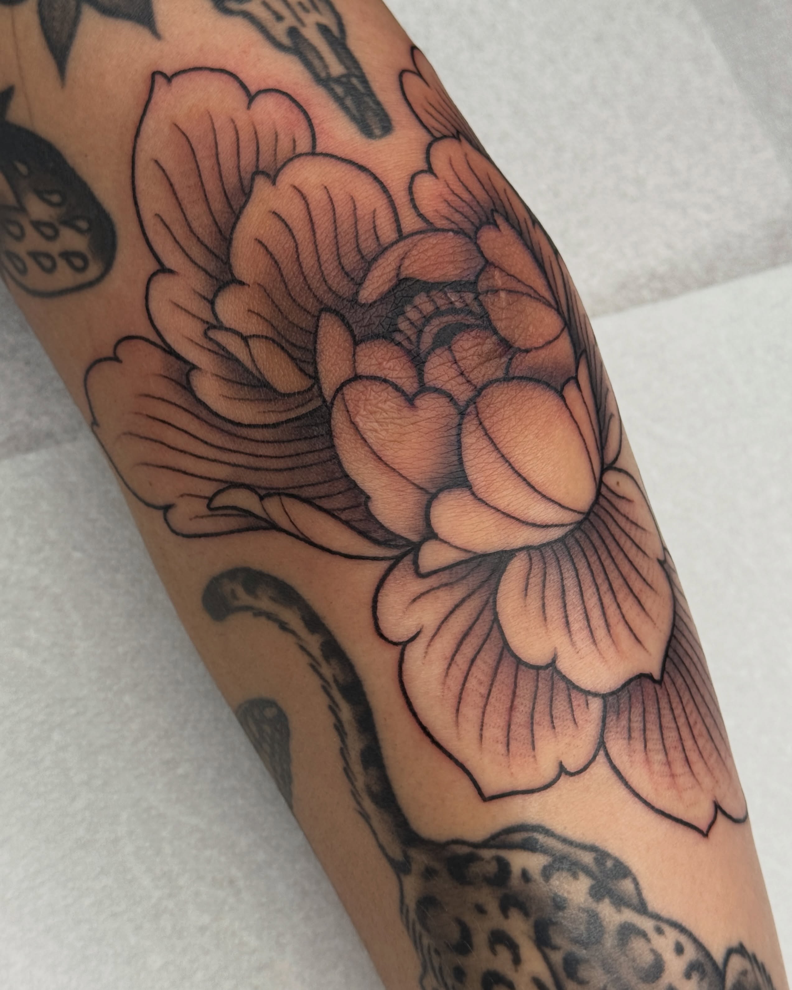 Peony American traditional tattoo on the forearm by Bre Grover, Vancouver, British Columbia