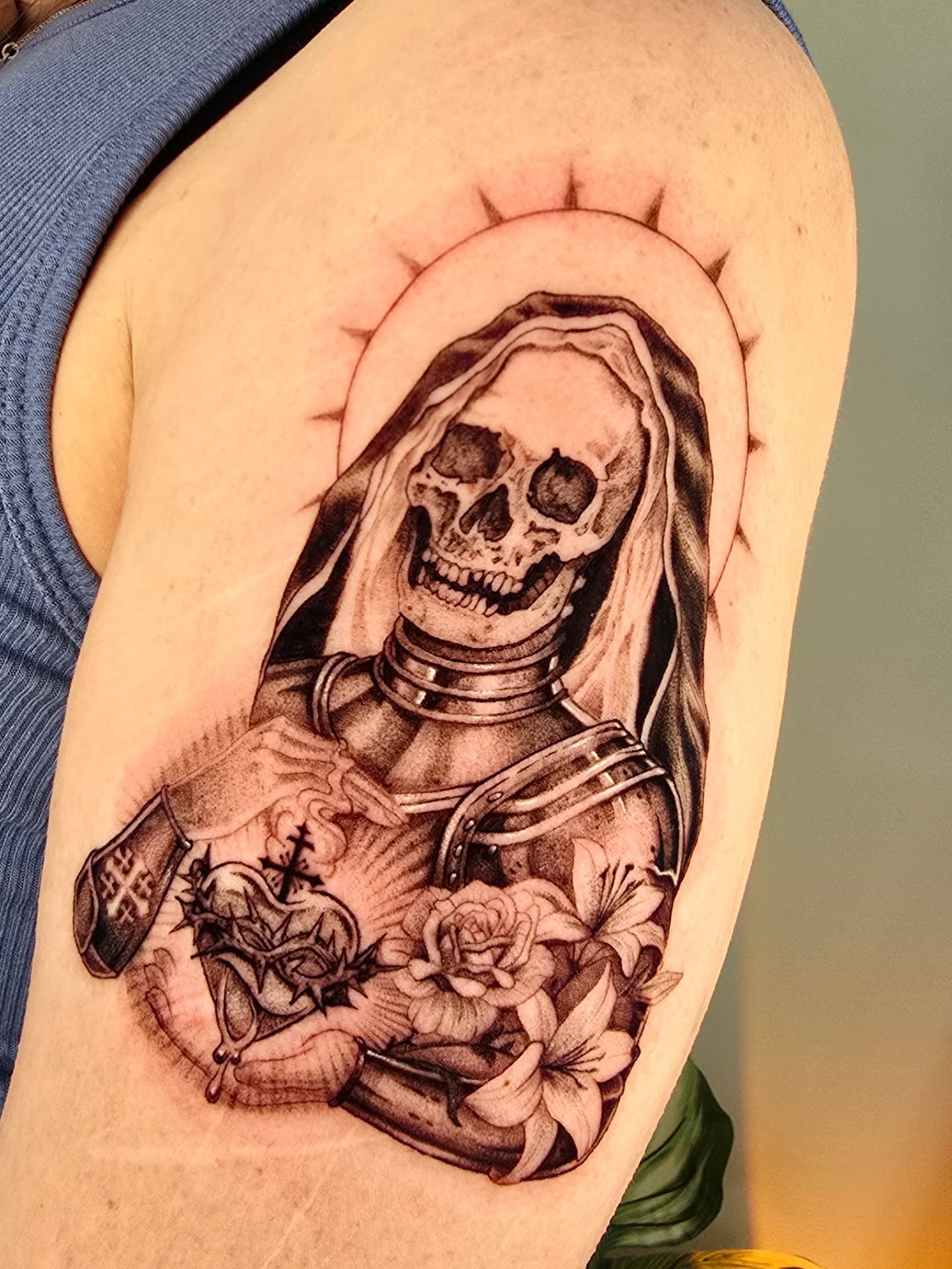 Skeleton with halo realism tattoo on the shoulder by Scribbles (Teala René), Charlotte, North Carolina