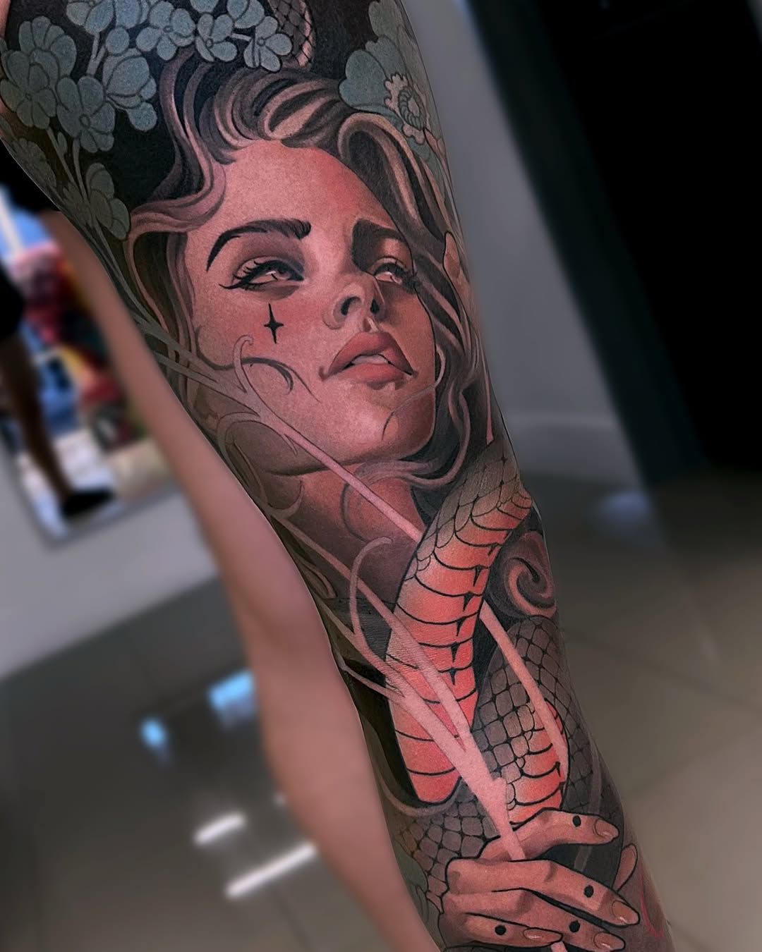 Woman and snake realism tattoo on the forearm by Levi Murphy