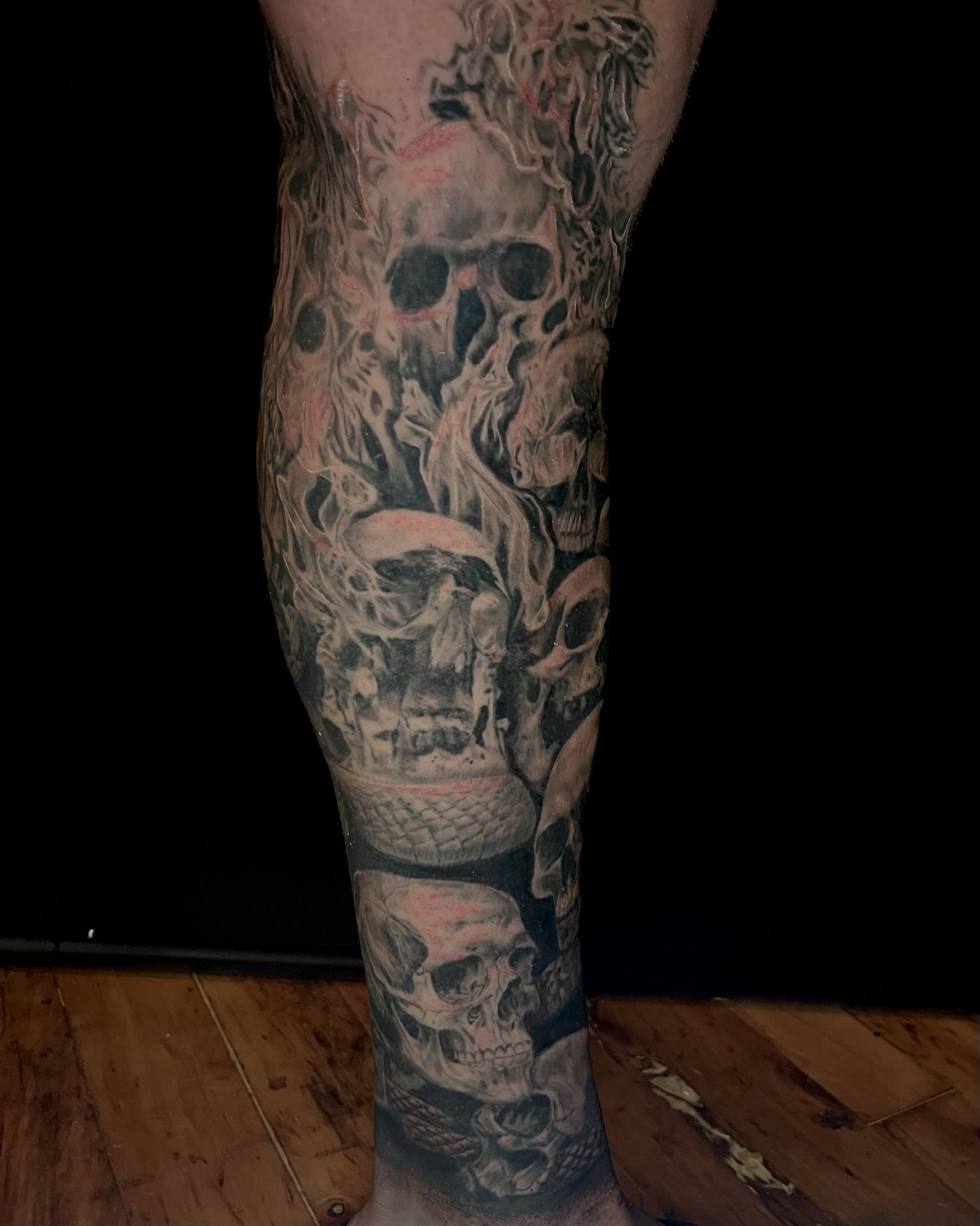 Skulls realism tattoo on the calf by EO, Chicago, Illinois