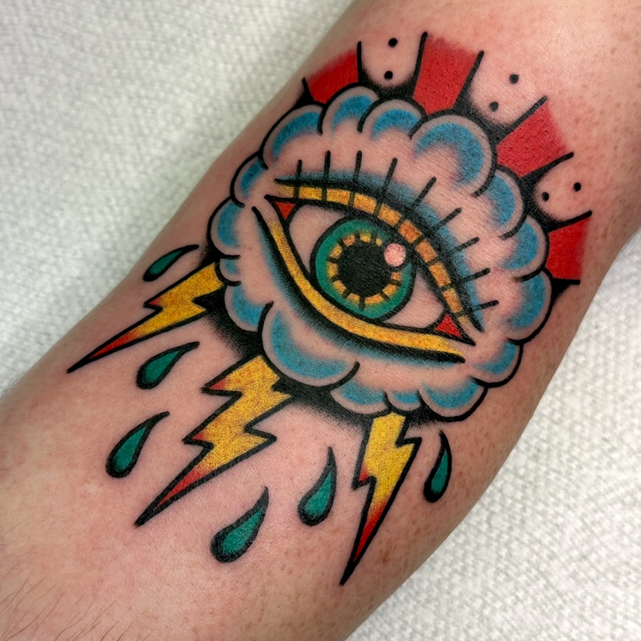 Eye with cloud and lightning American traditional tattoo on the forearm by Amanda Bonhomme, Las Vegas, Nevada