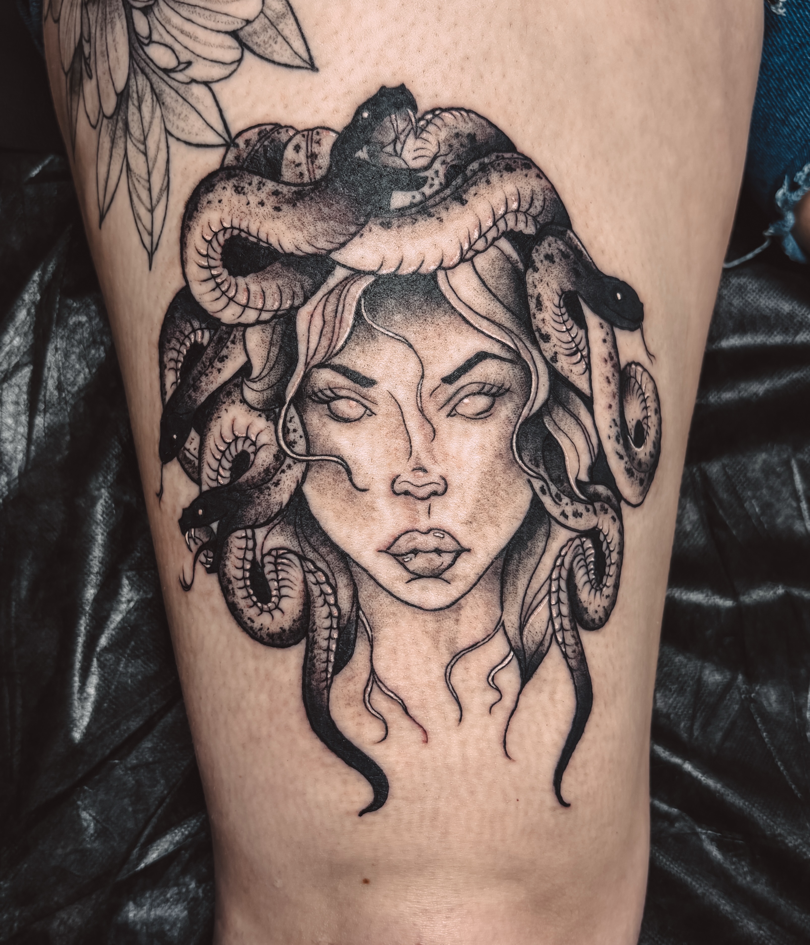 Medusa realism tattoo on the thigh by Liz Cook