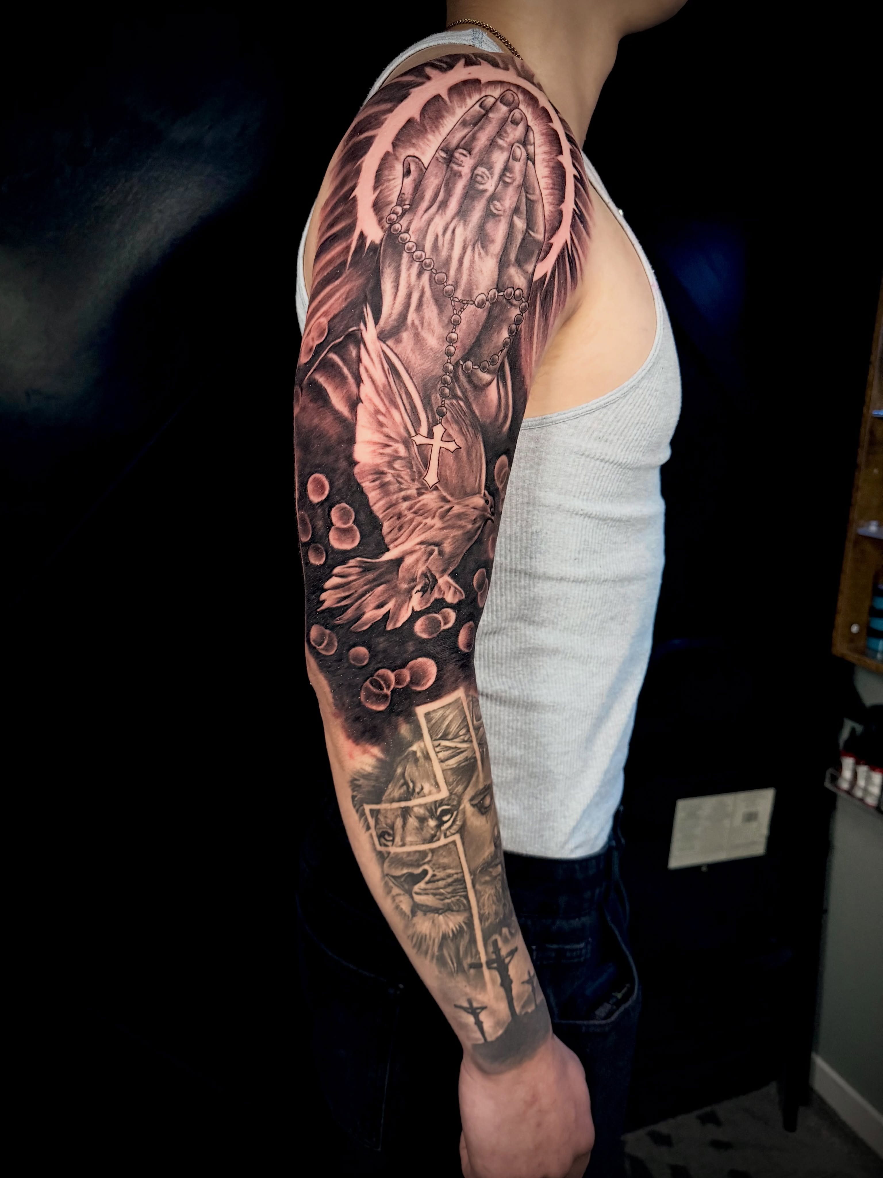 Praying hands with rosary realism tattoo on the forearm by John Ayson, Murrieta, California