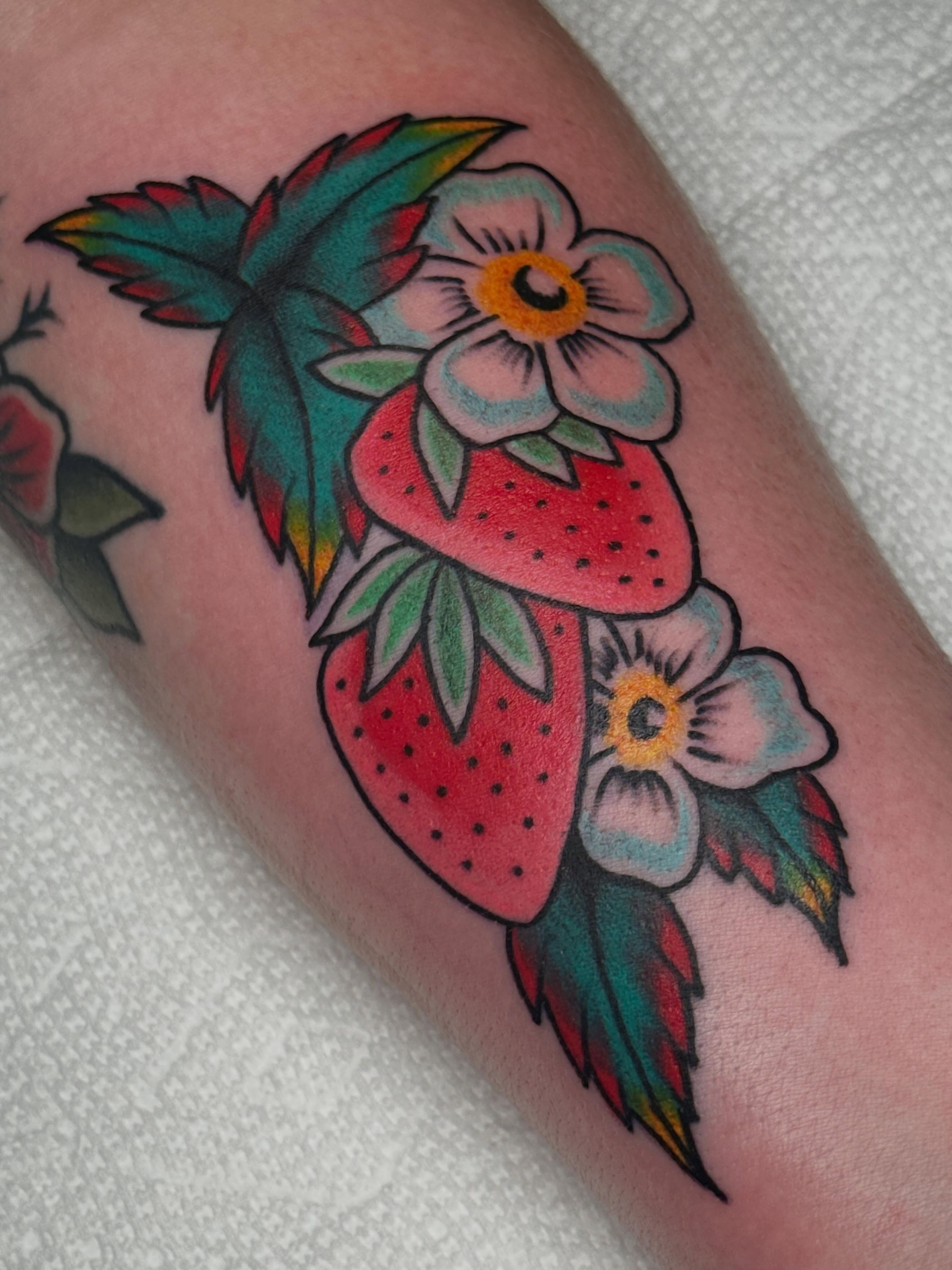 Strawberry and flowers American traditional tattoo on the forearm by Colbylee Tattoo Norwich