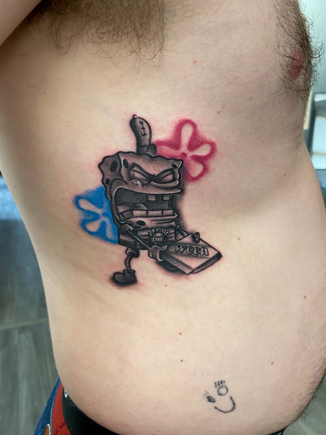 SpongeBob SquarePants black and grey tattoo on the ribs by Kelan Mckenna