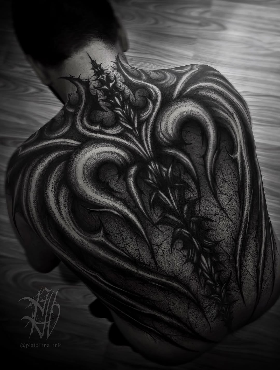 Ornamental spine and wings cyber sigilism tattoo on the back by Dark Gothic Tattoo