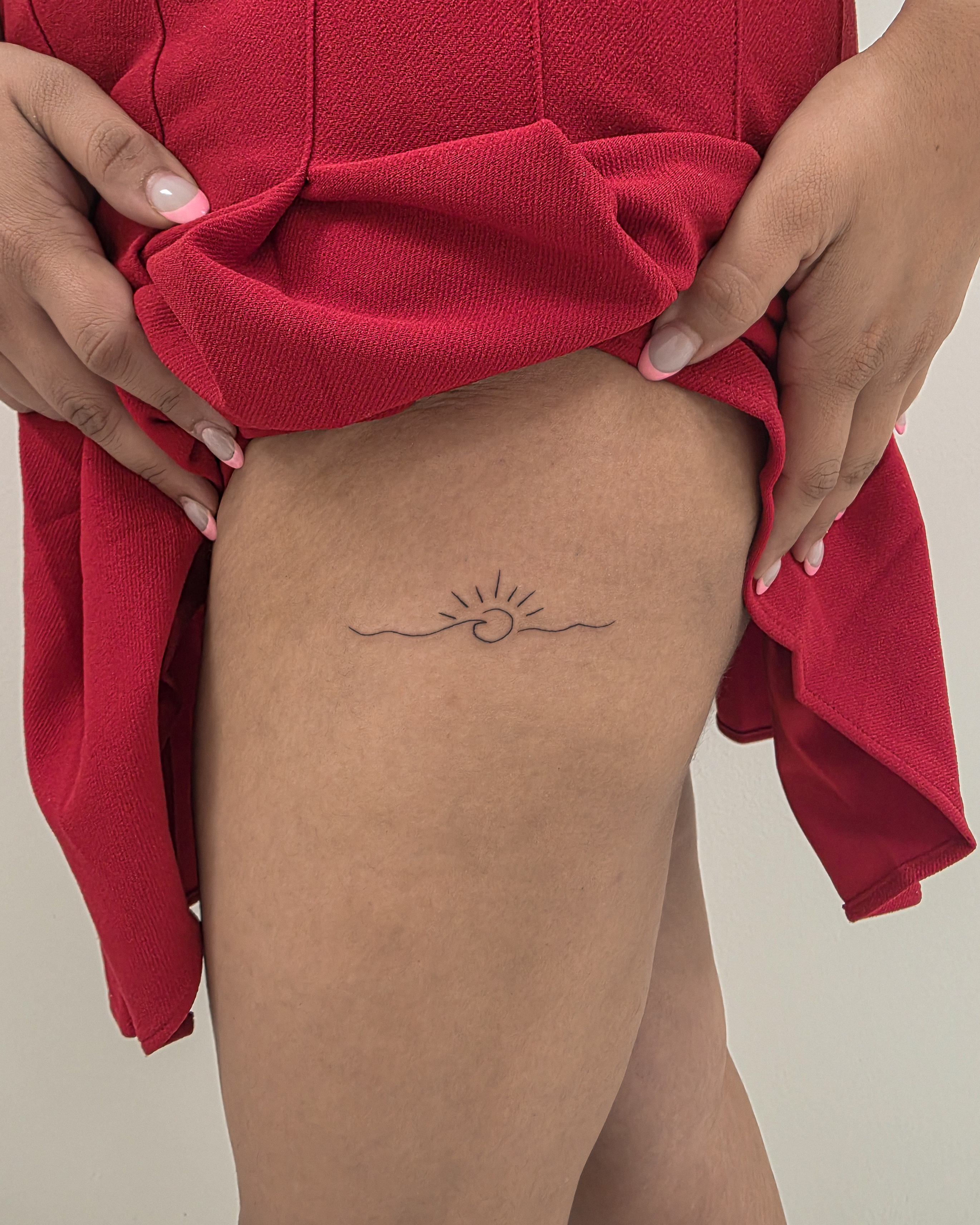 Sun and wave fine line tattoo on the thigh by Richmond tattoo shop, Richmond, Texas