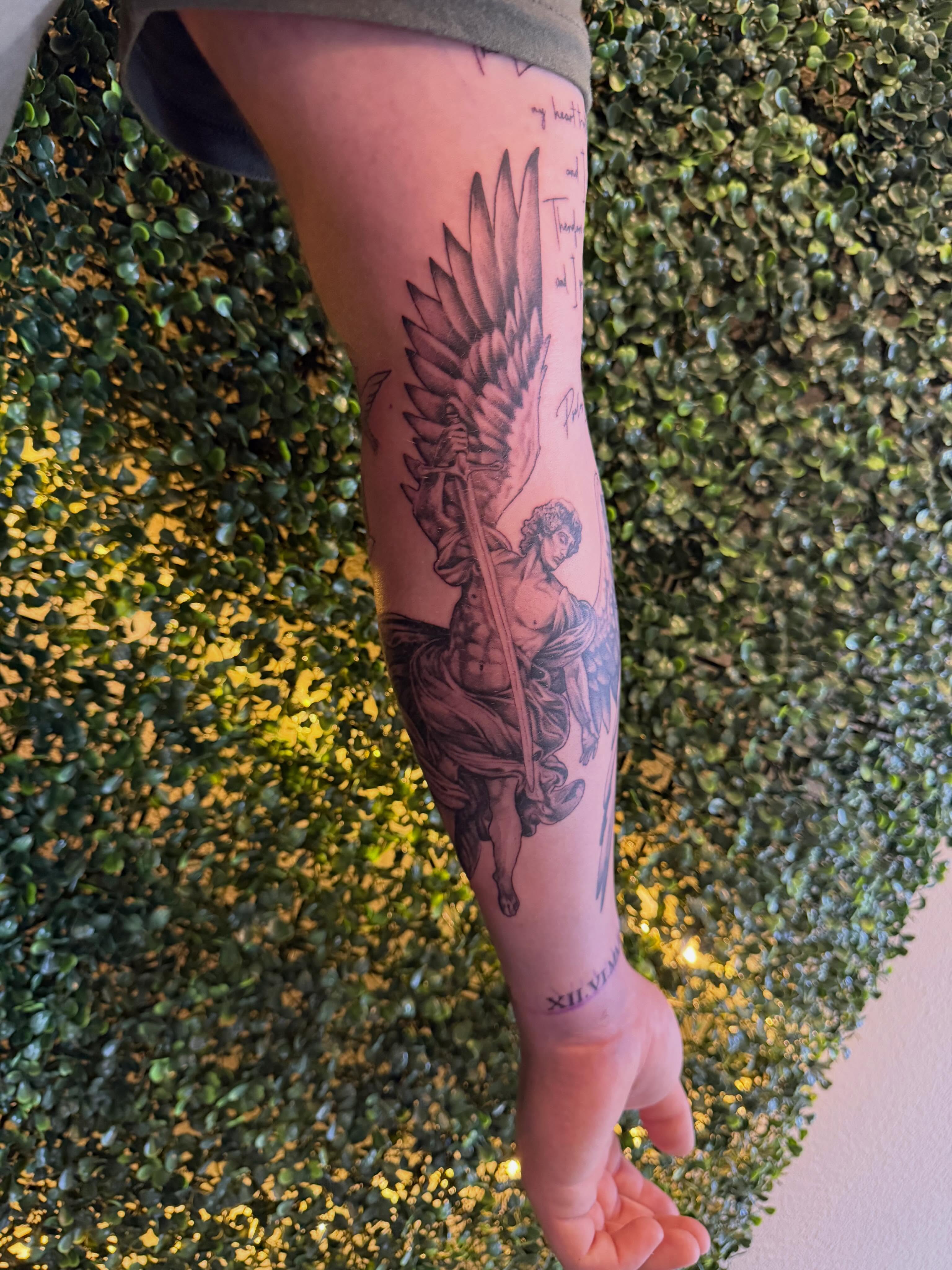 Angel with sword black and grey tattoo on the forearm by Lauren Horness
