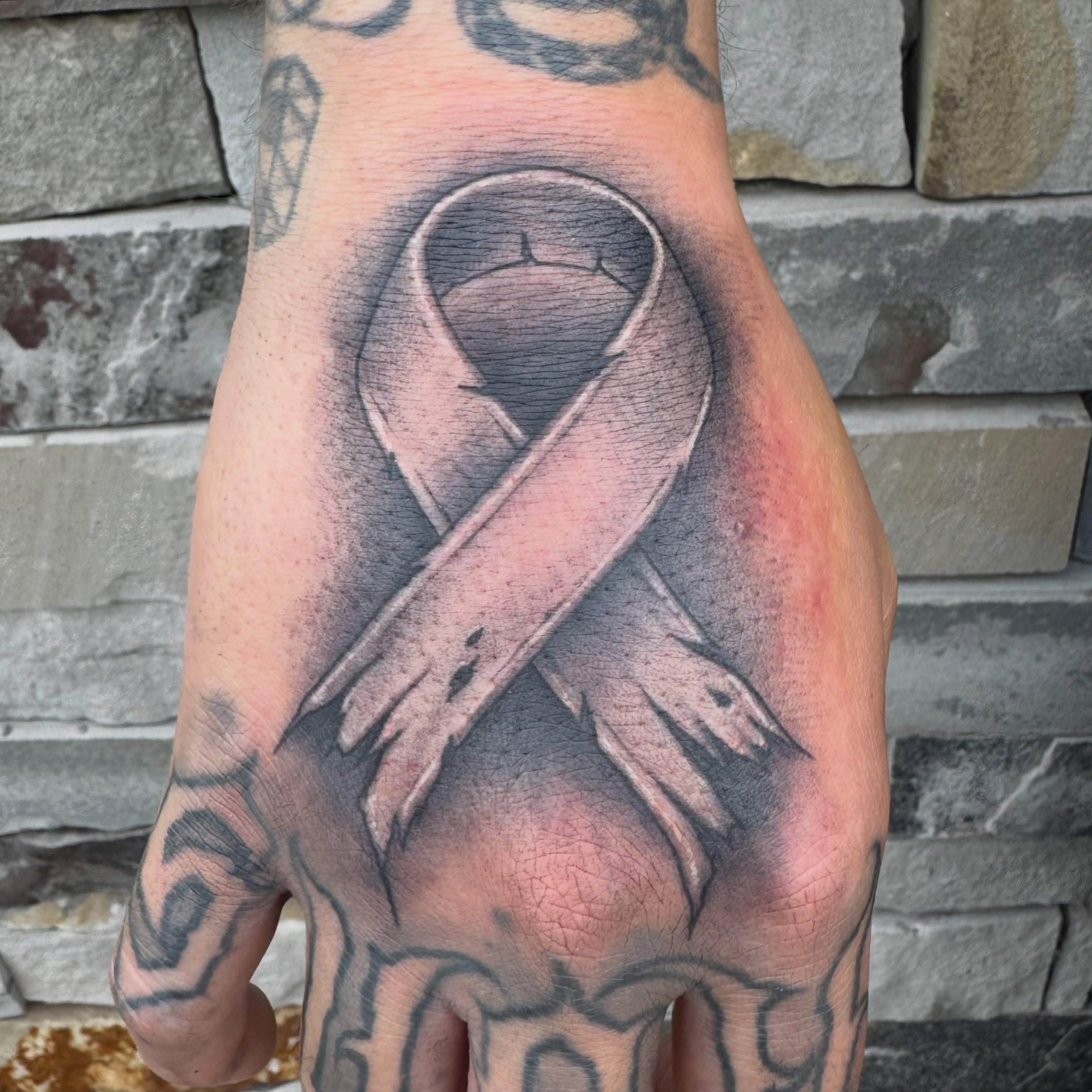 Breast cancer awareness ribbon realism tattoo on the hand by 𝕷𝖚𝖎𝖘 𝕲ü𝖊𝖗𝖊𝖈𝖆