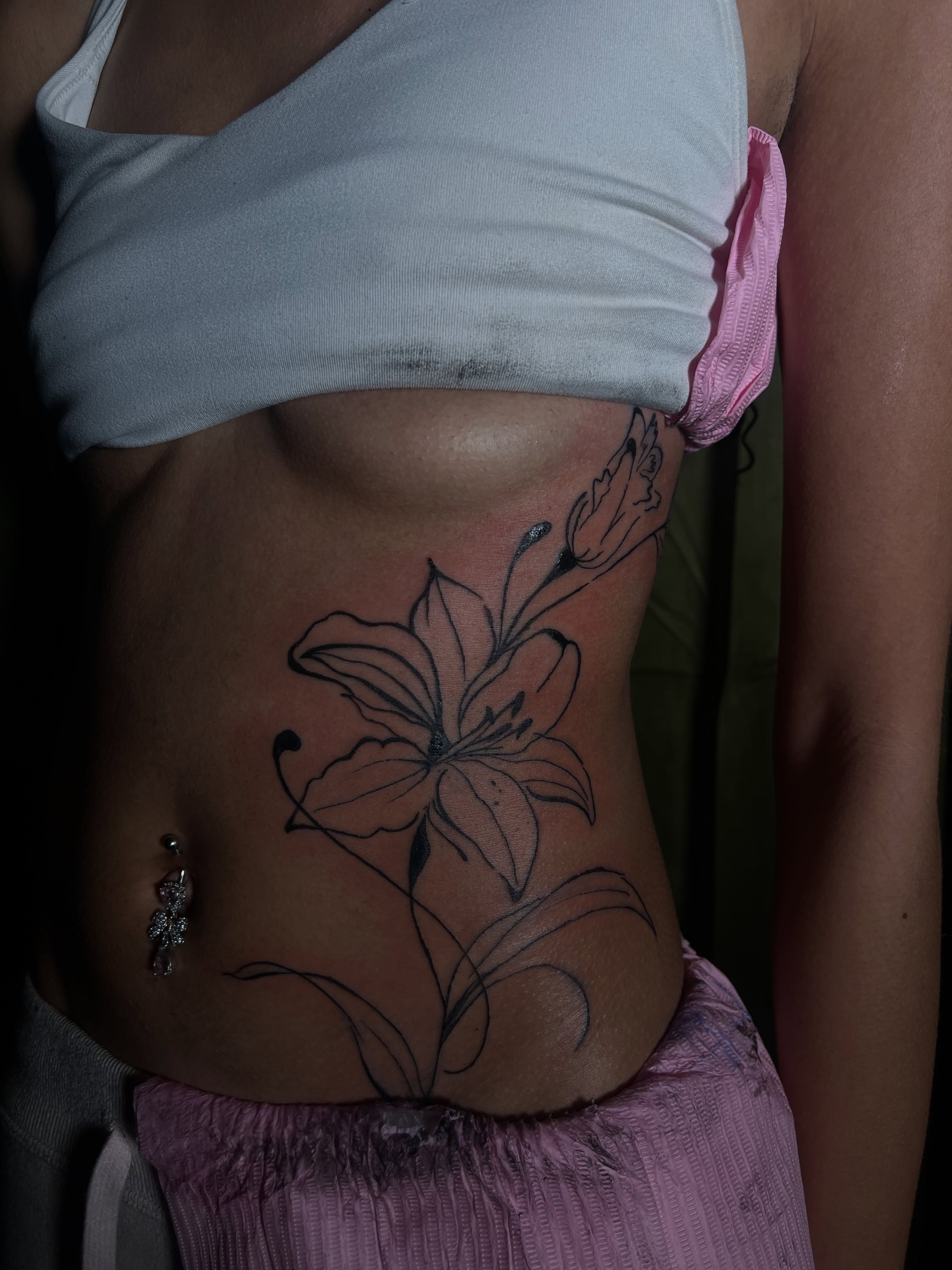 Lily black and grey tattoo on the torso by V