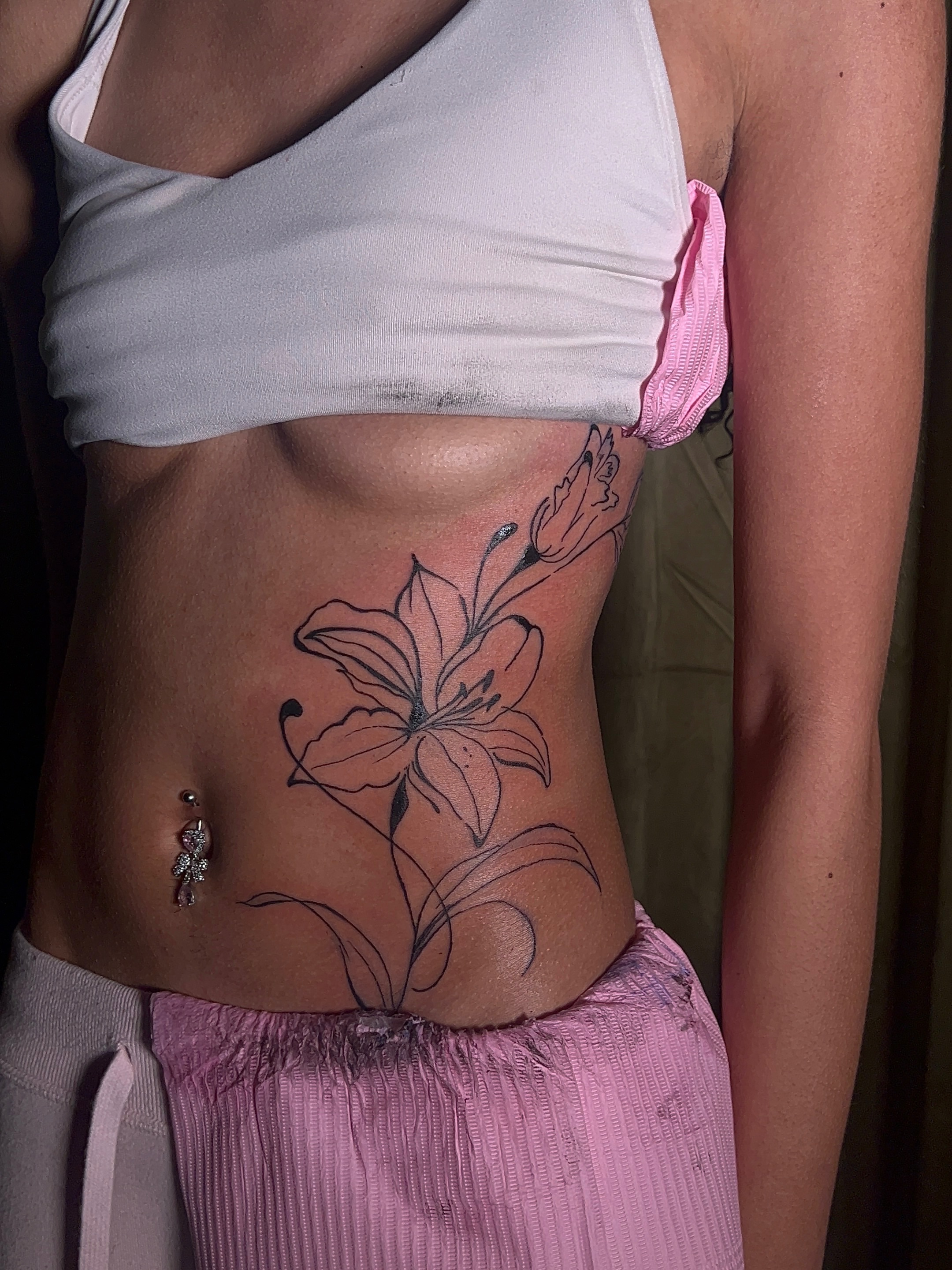 Lily black and grey tattoo on the torso by V