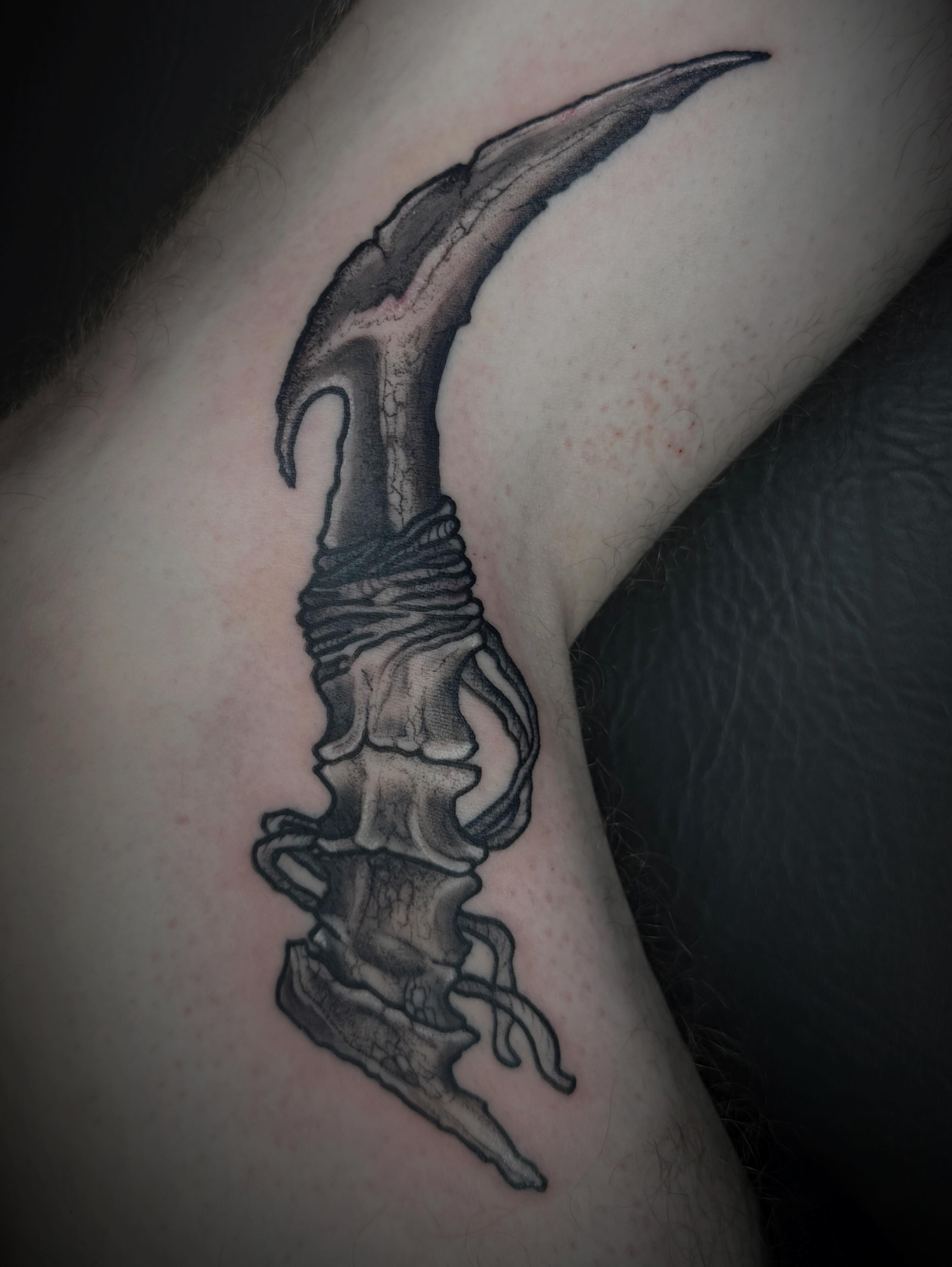 Bone structure with hook black and grey tattoo on the forearm by sᴋᴇᴛᴄʜᴇᴅ