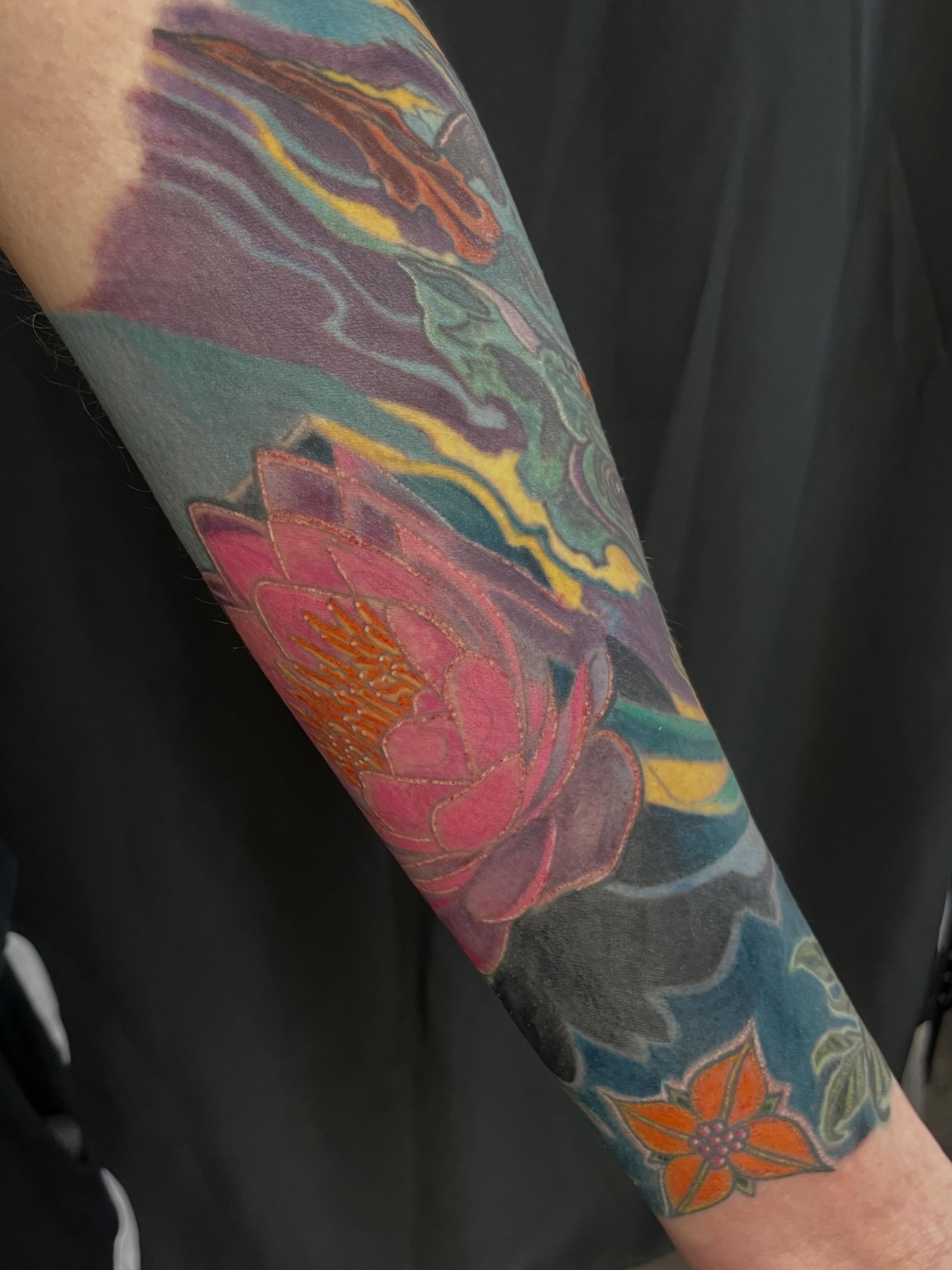 Lotus flower new school tattoo on the forearm by Joey Taylor