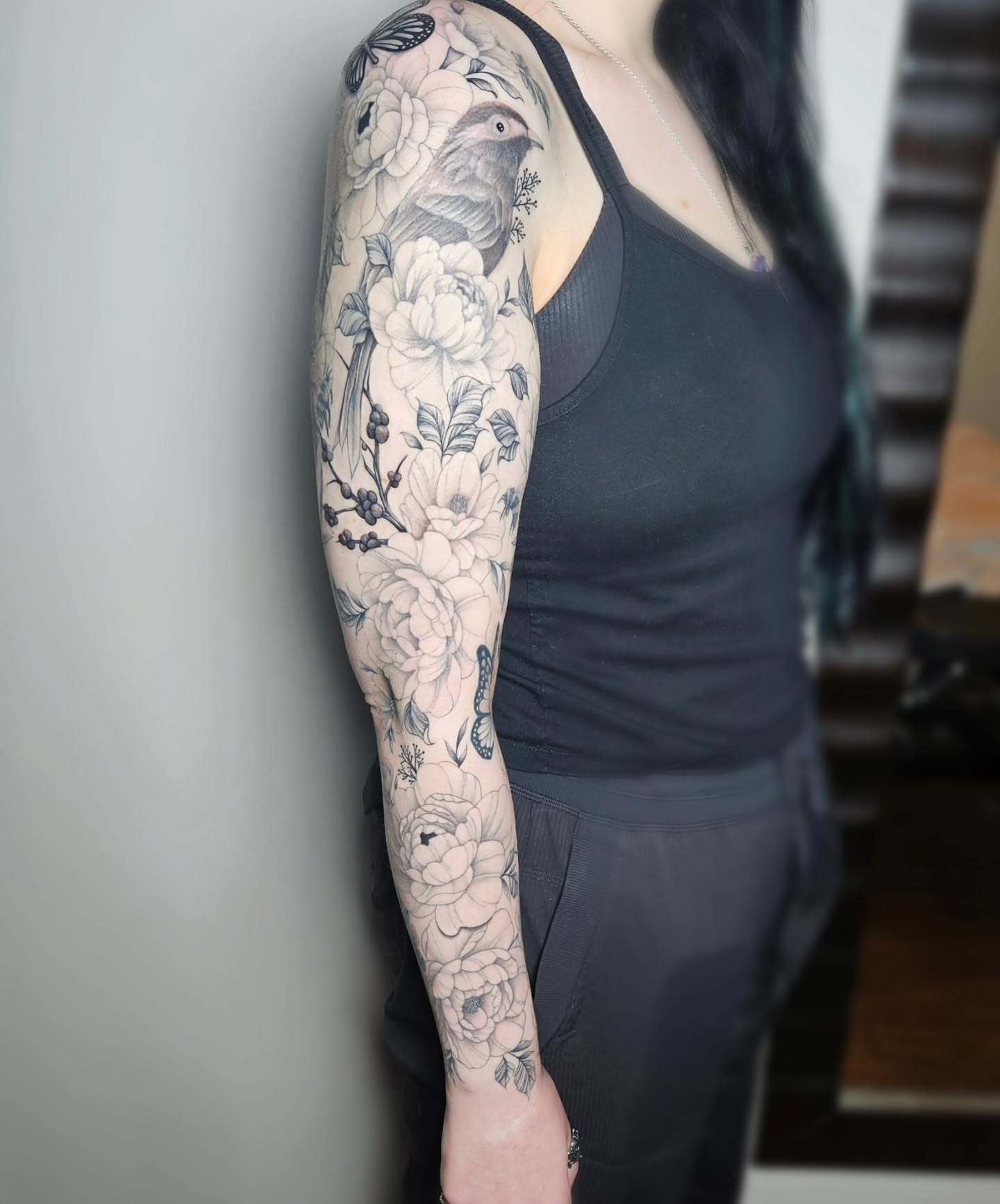 Bird and floral bouquet realism tattoo on the upper arm by TaylorLeighShermanTattoos OFFICIAL