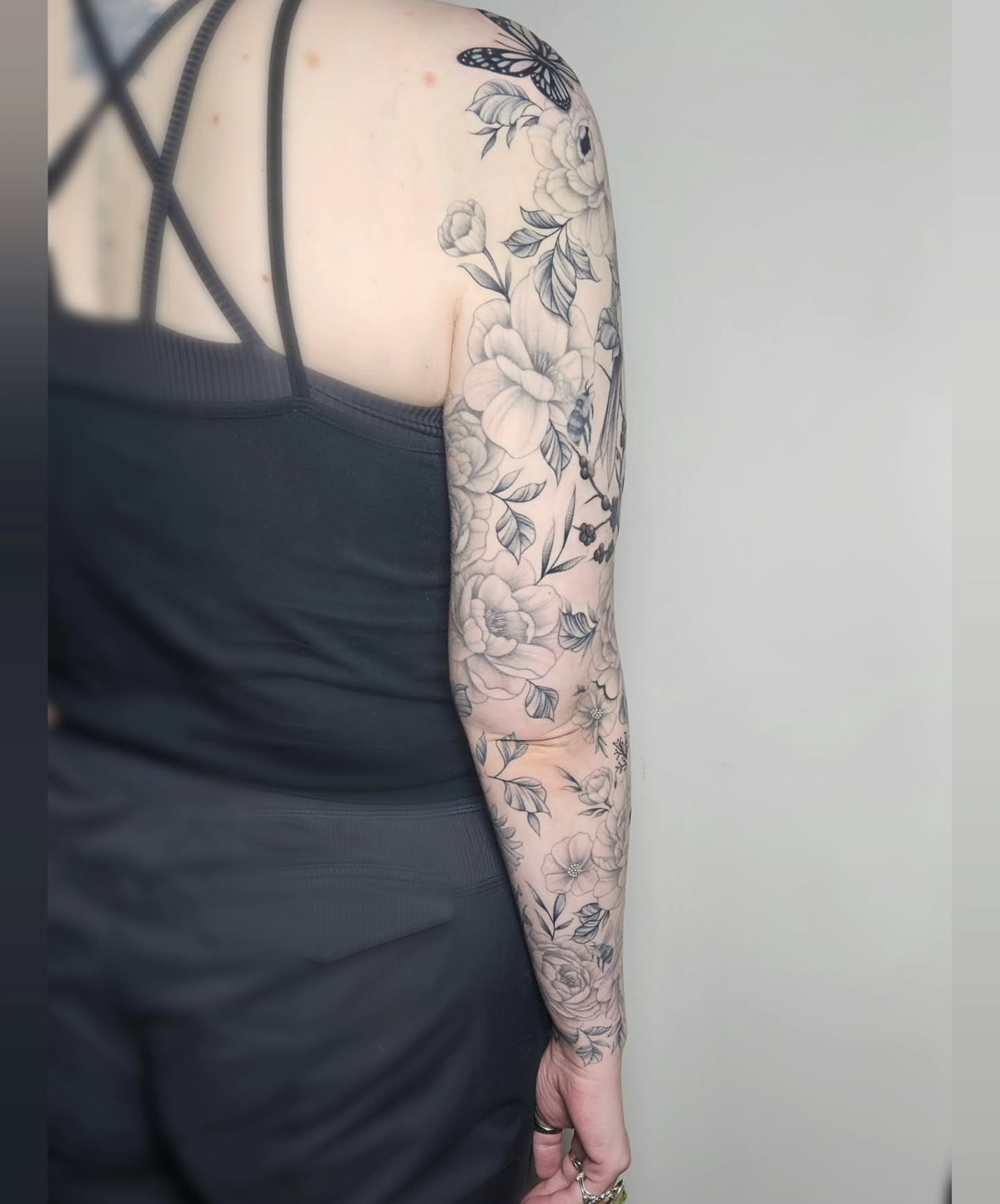 Floral bouquet black and grey tattoo on the upper arm by TaylorLeighShermanTattoos OFFICIAL
