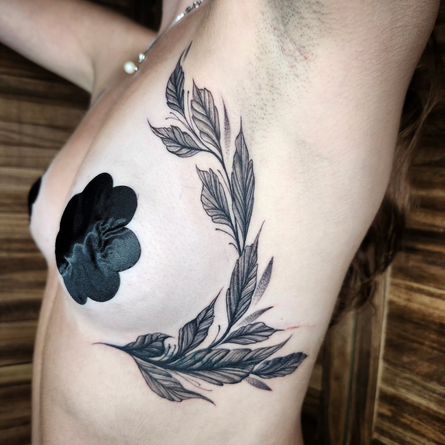 Flower and leaves black and grey tattoo on the shoulder by Kelly Zito