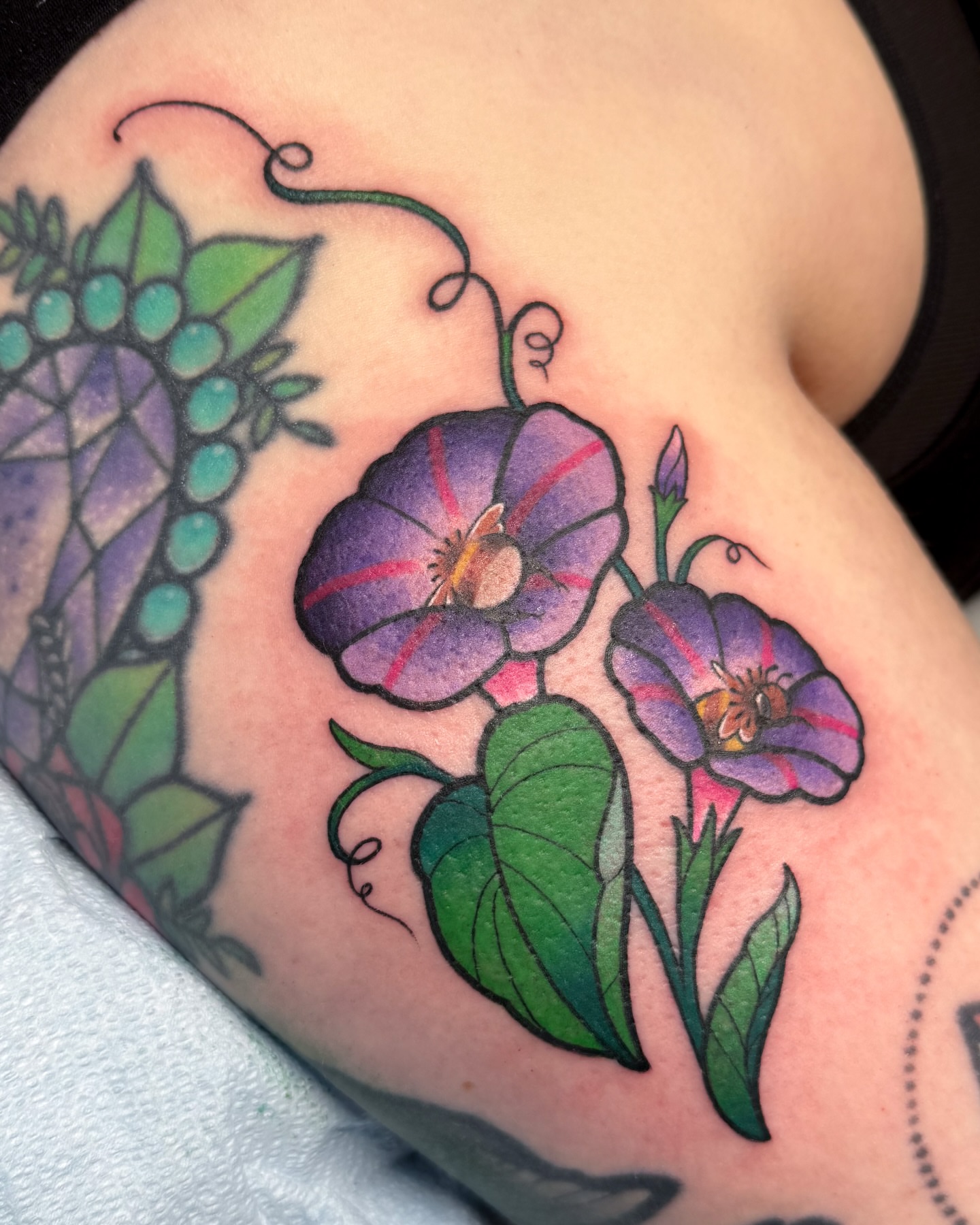 Morning glory flowers American traditional tattoo on the shoulder by Janine Ramos