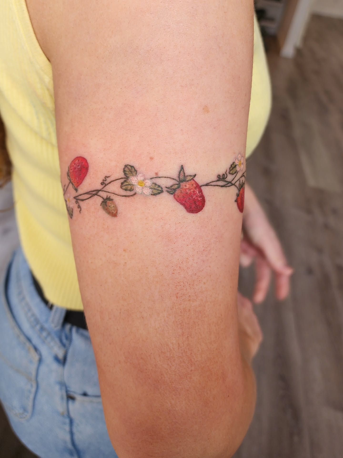 Strawberries and flowers dotwork tattoo on the forearm by mikayla