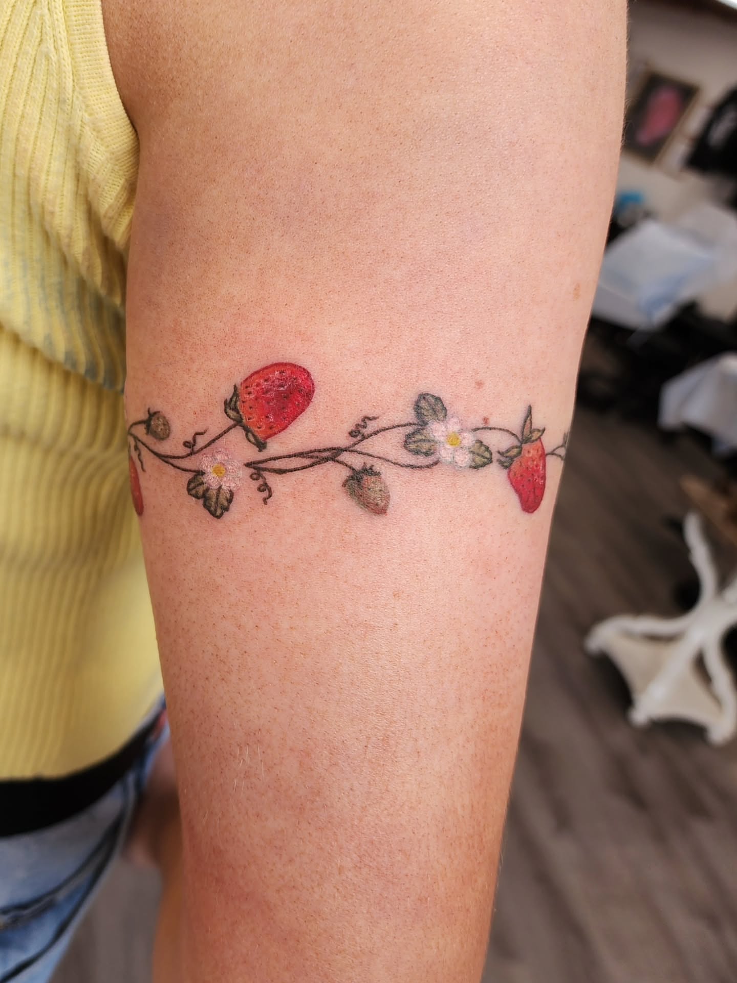 Strawberry vine watercolor tattoo on the forearm by mikayla