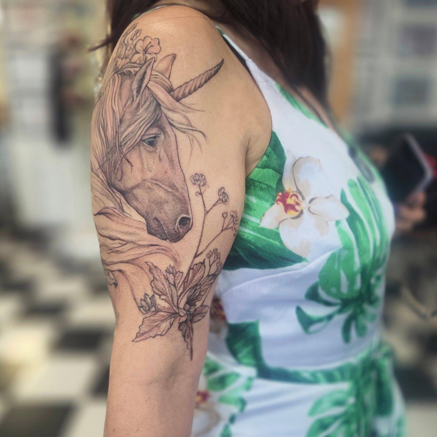 Unicorn realism tattoo on the upper arm by Molly DeSmedt