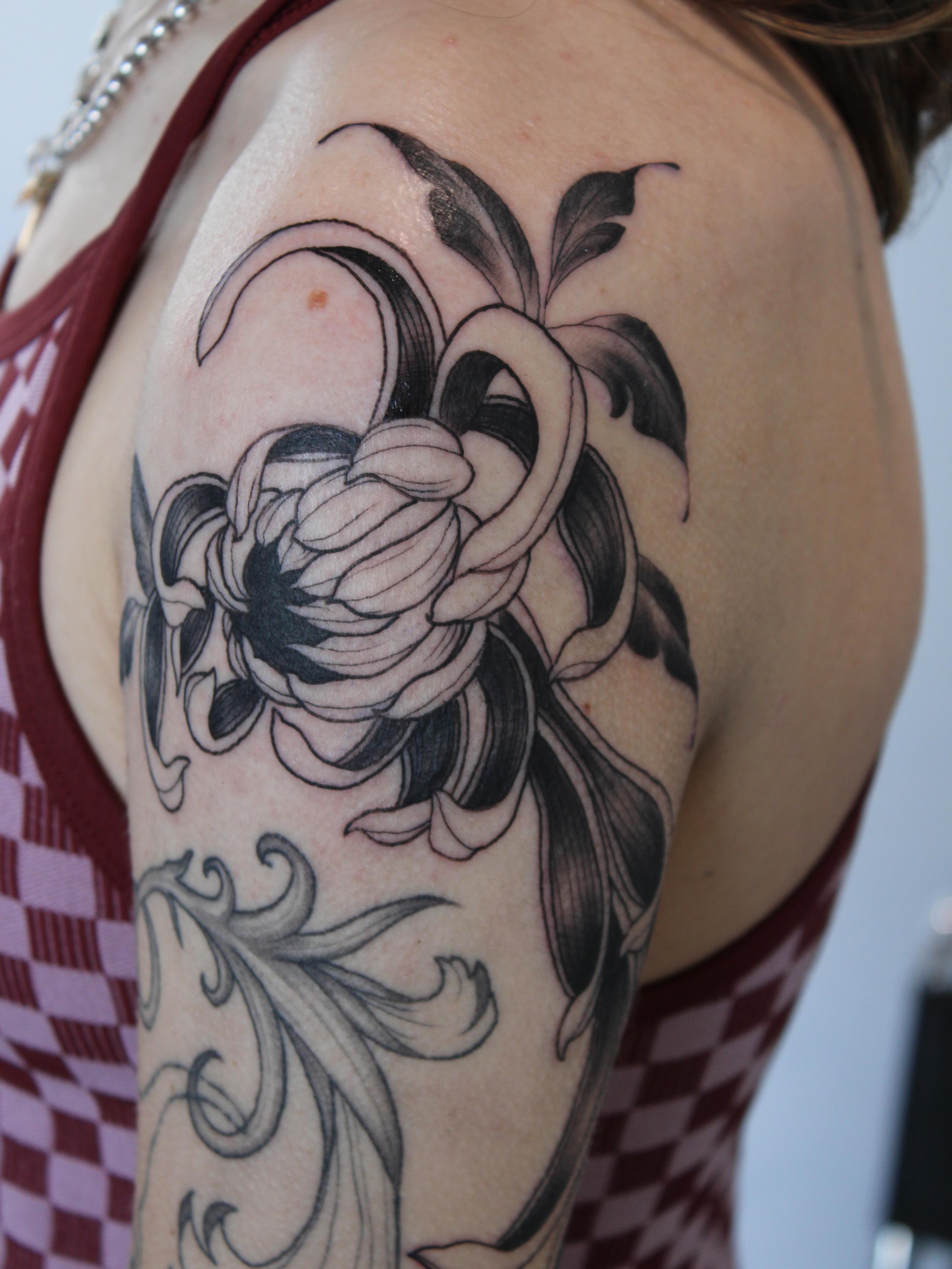 Flower black and grey tattoo on the shoulder by Julianna