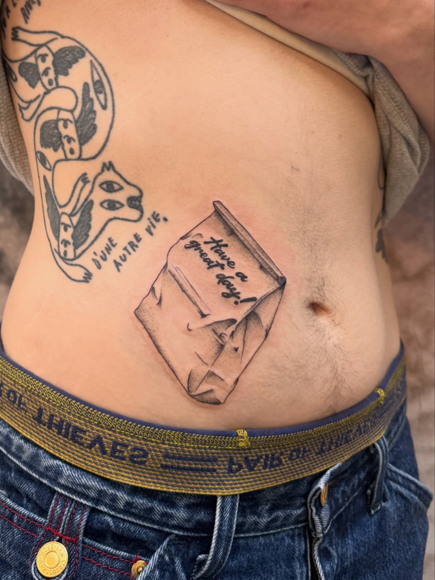 Book with message black and grey tattoo on the ribs by Sam Padilla