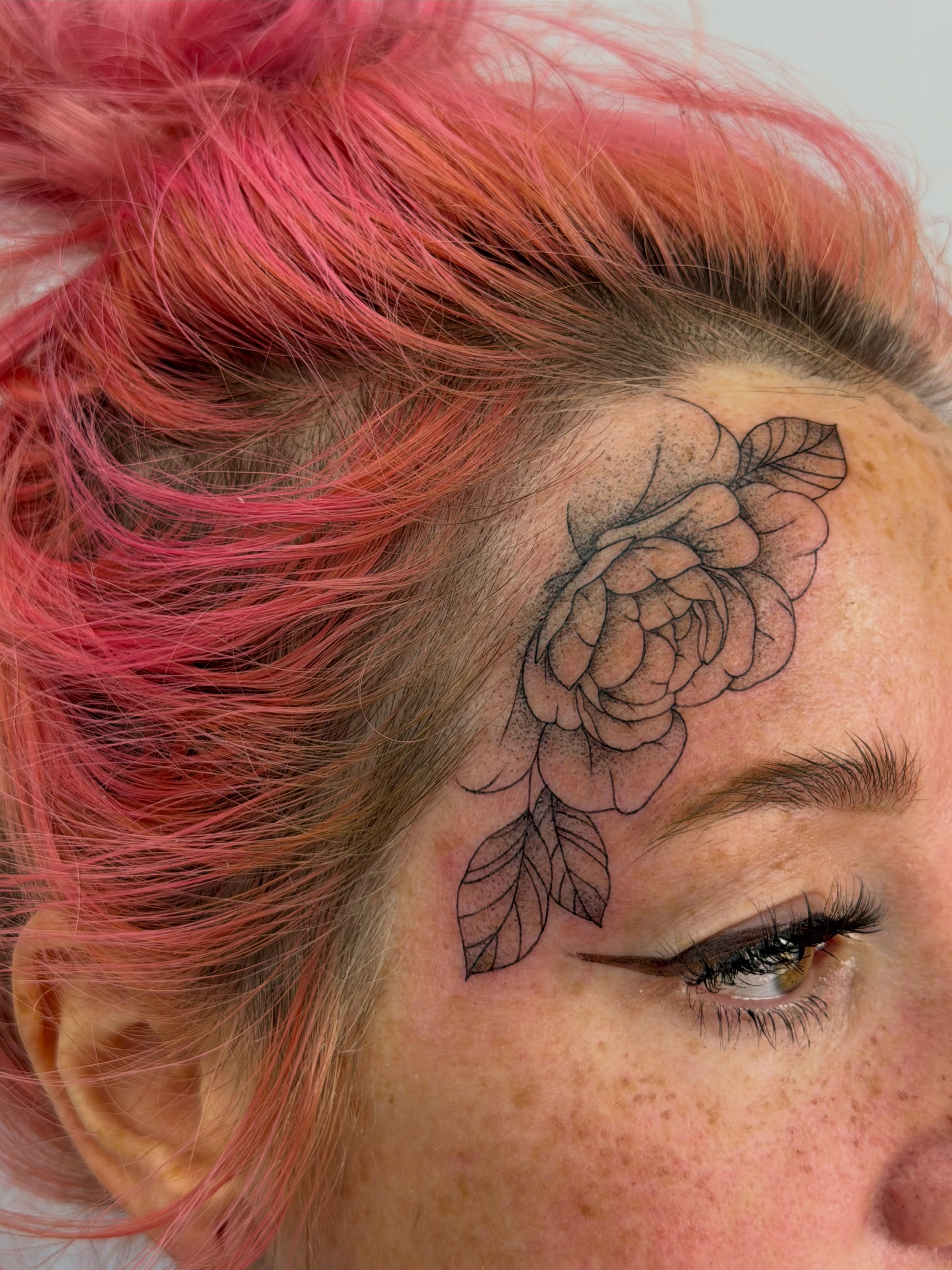 Rose black and grey tattoo on the head by Henesee Parfitt