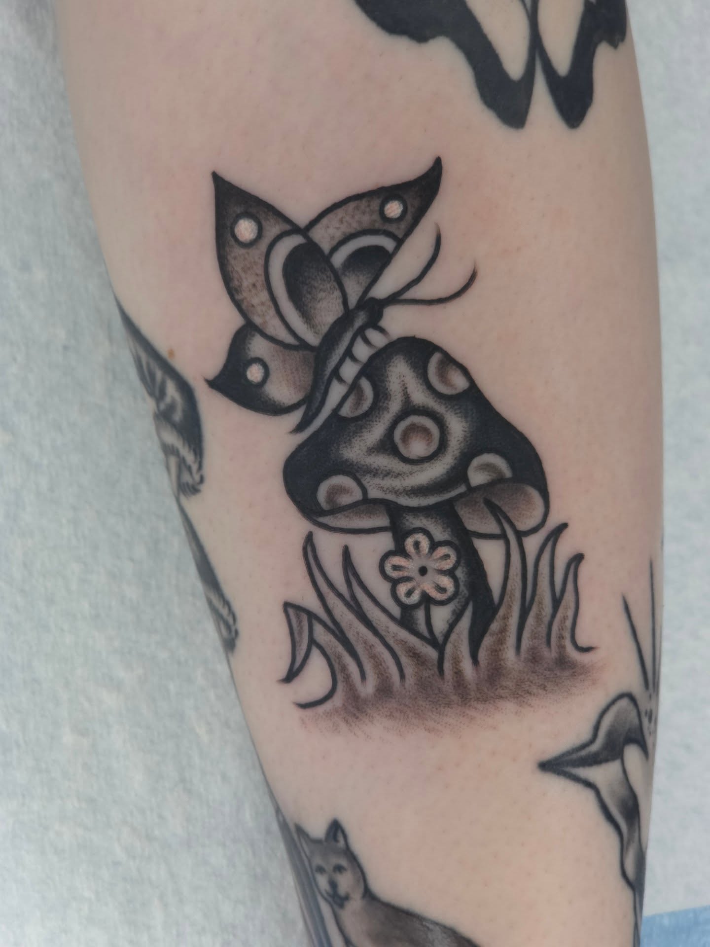 Mushroom and butterfly black and grey tattoo on the forearm by Clayton Harpole, Jefferson, Oregon