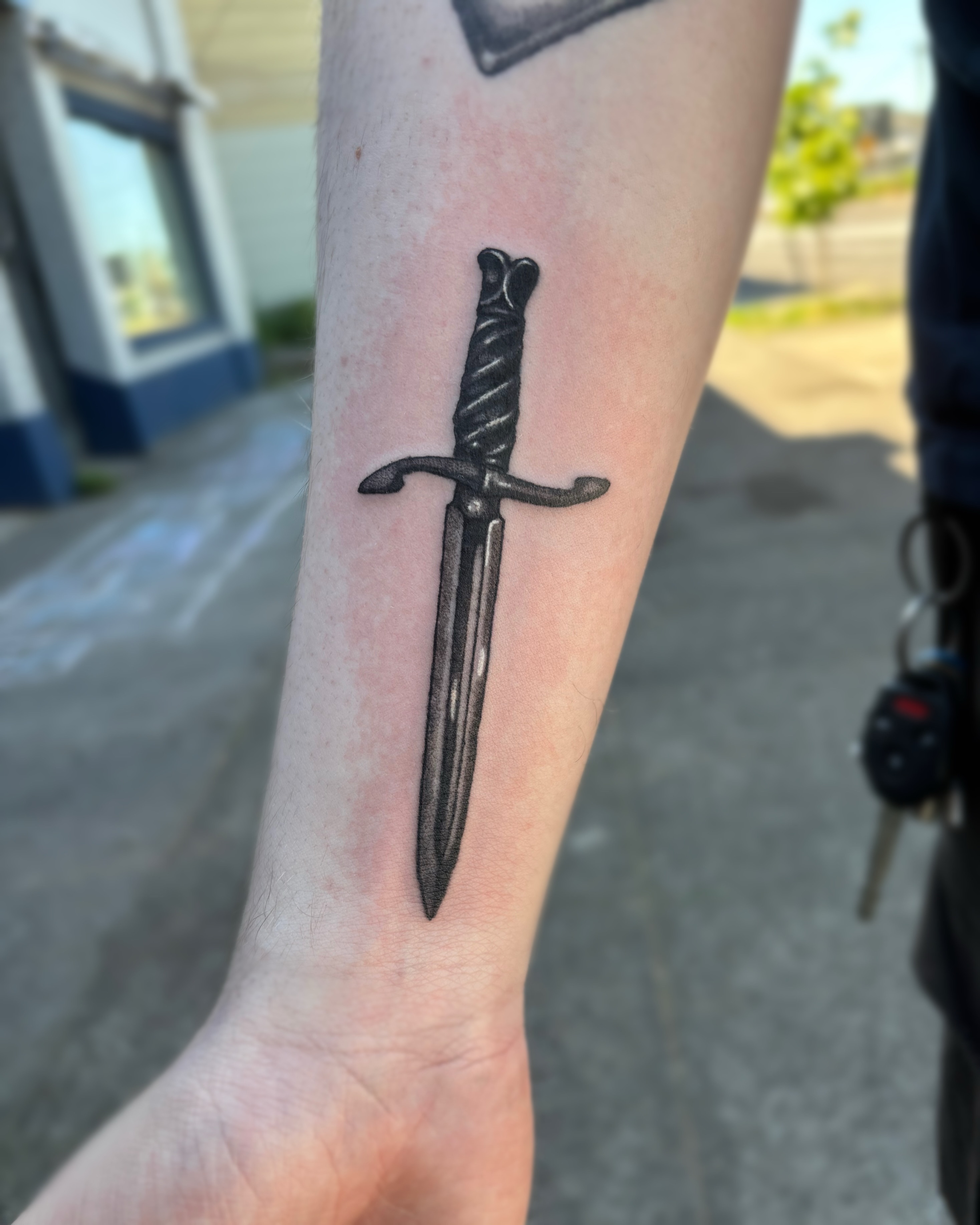 Sword black and grey tattoo on the forearm by Cooper, Portland, Oregon