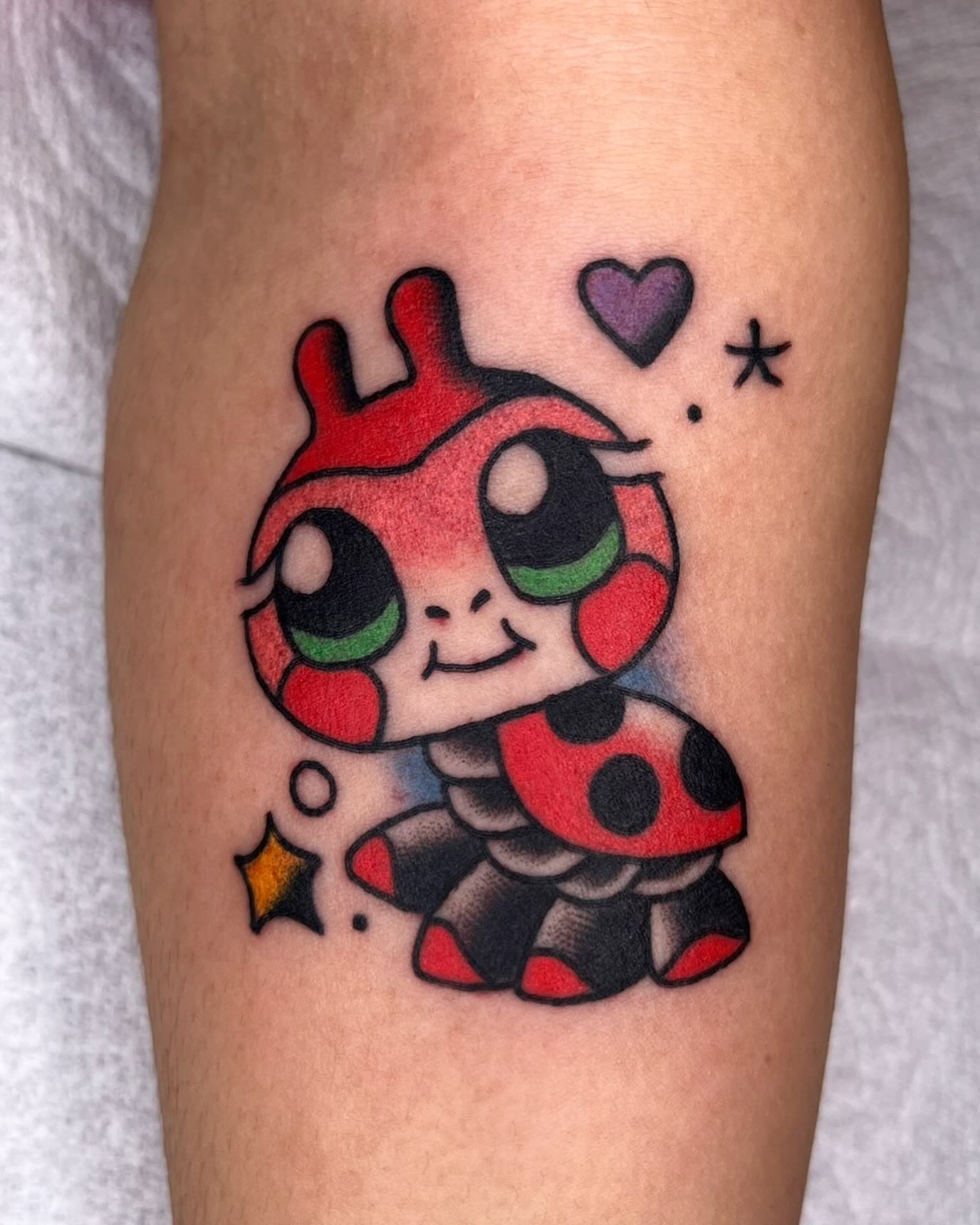 Ladybug dotwork tattoo on the forearm by Robyn Fricke