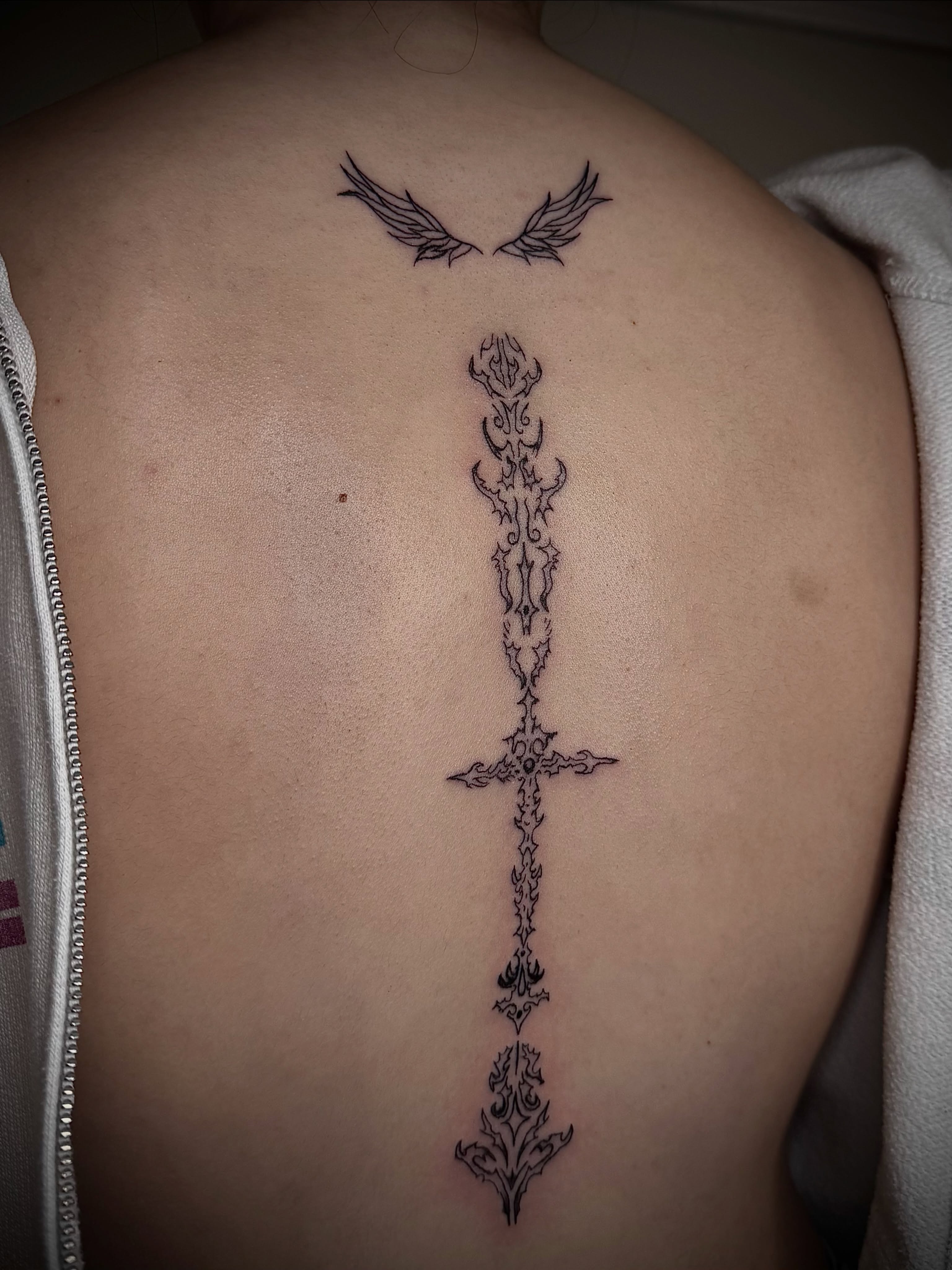 Cross with ornate details ornamental tattoo on the back by dev