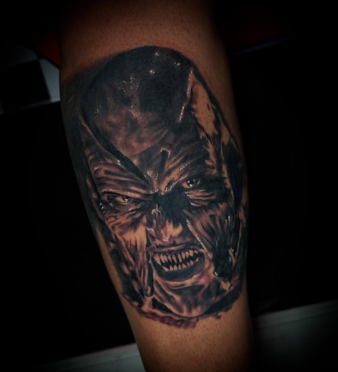 Angry demon face dark realism tattoo on the forearm by Savannah Duff